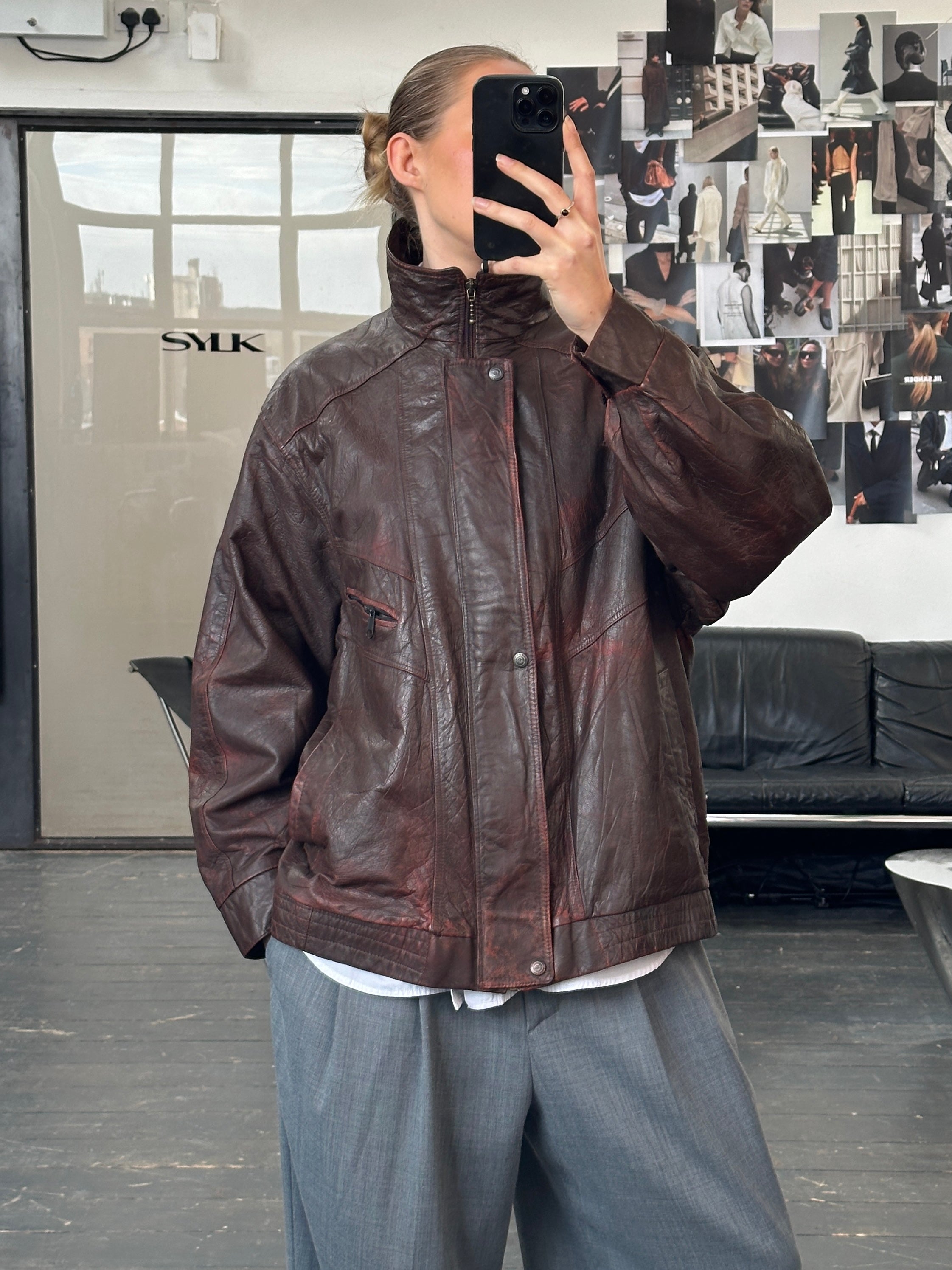 Vintage 1990s leather bomber jacket with funnel neck in aged leather, size XL, featuring classic vintage styling.