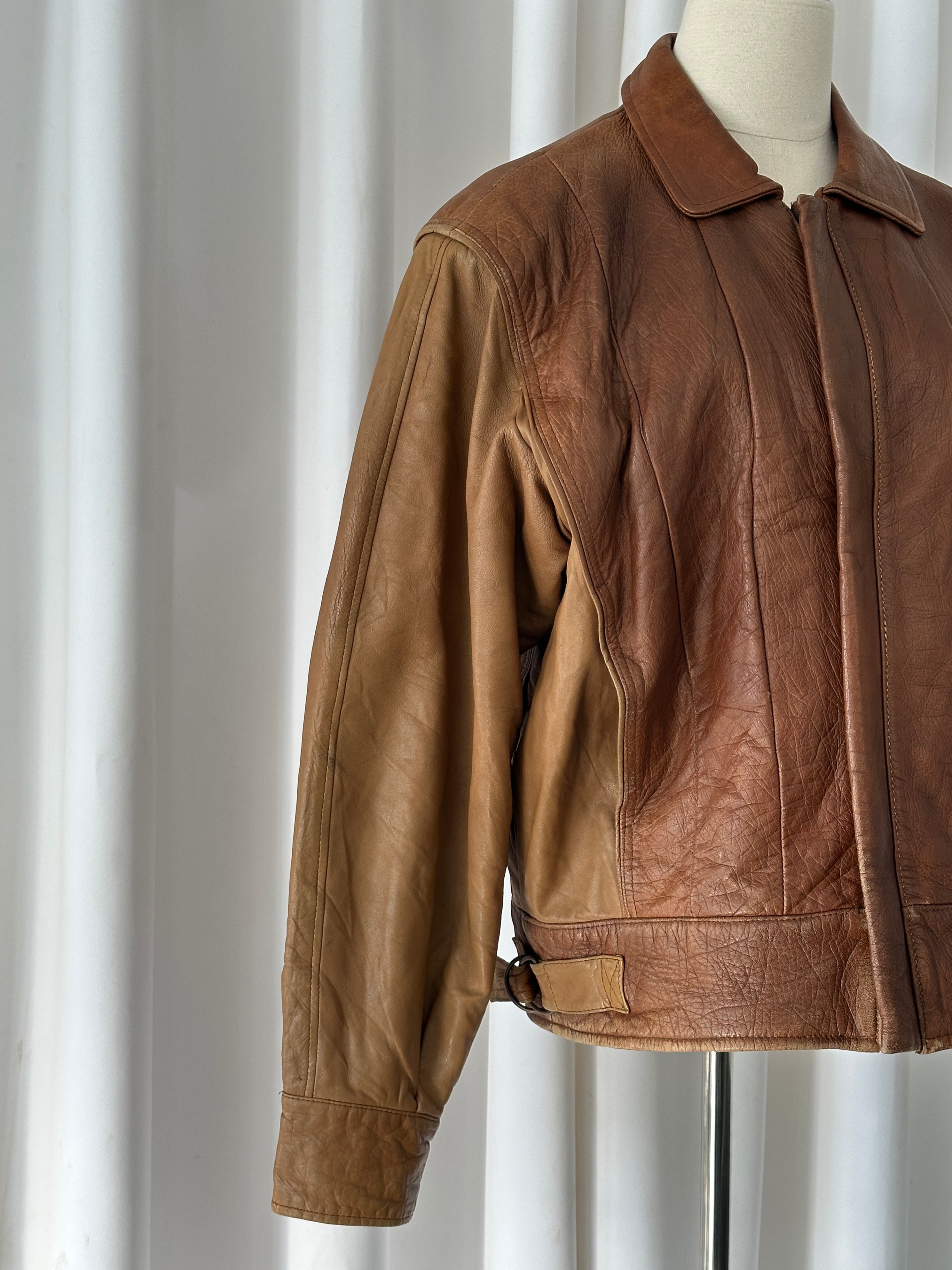 Vintage Italian 1980s leather bomber jacket with classic design, medium-large size, featuring aged brown leather and vintage style details.