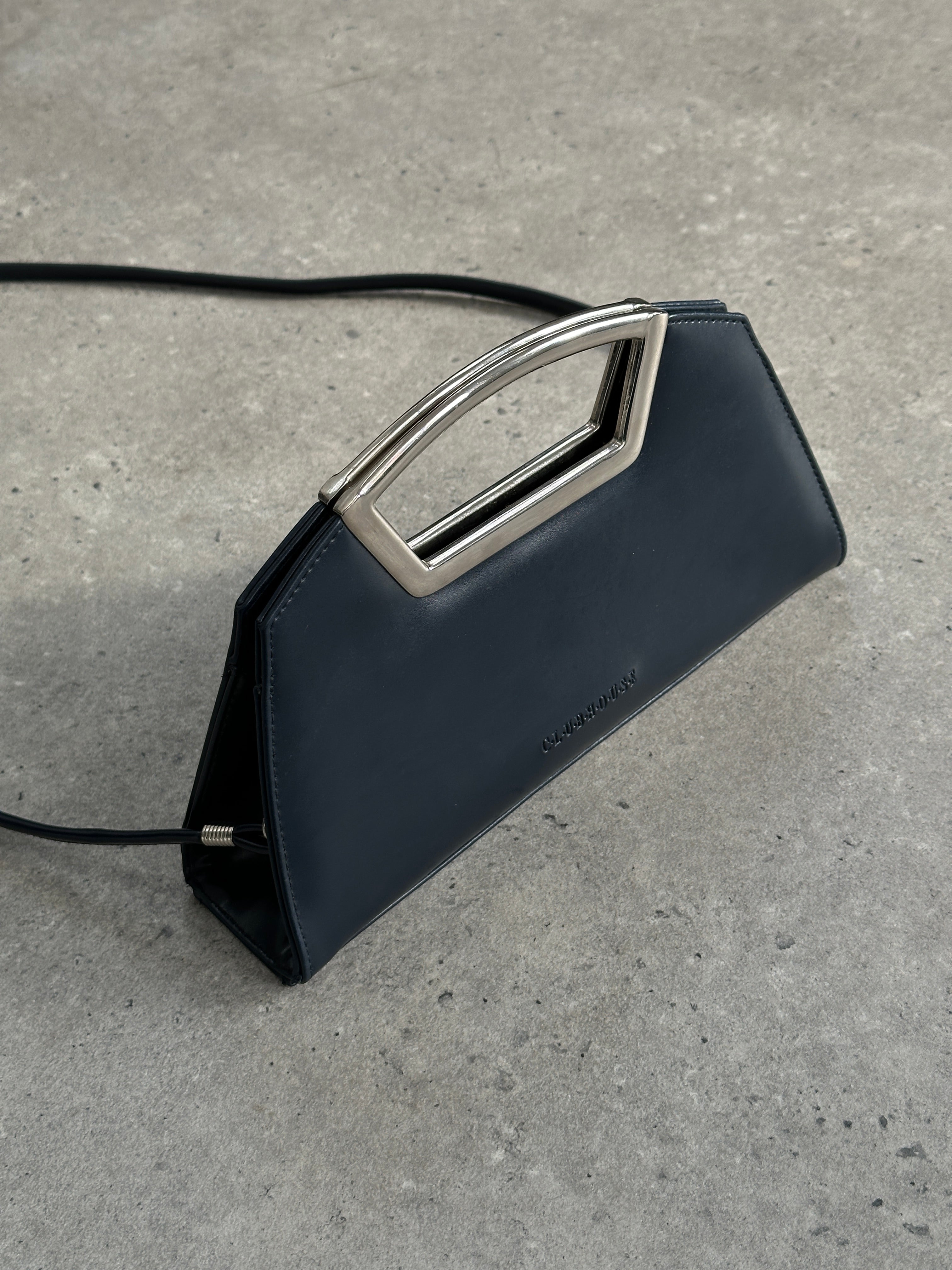Vintage leather chrome crossbody clutch bag with adjustable strap and classic design, perfect for stylish everyday carry.