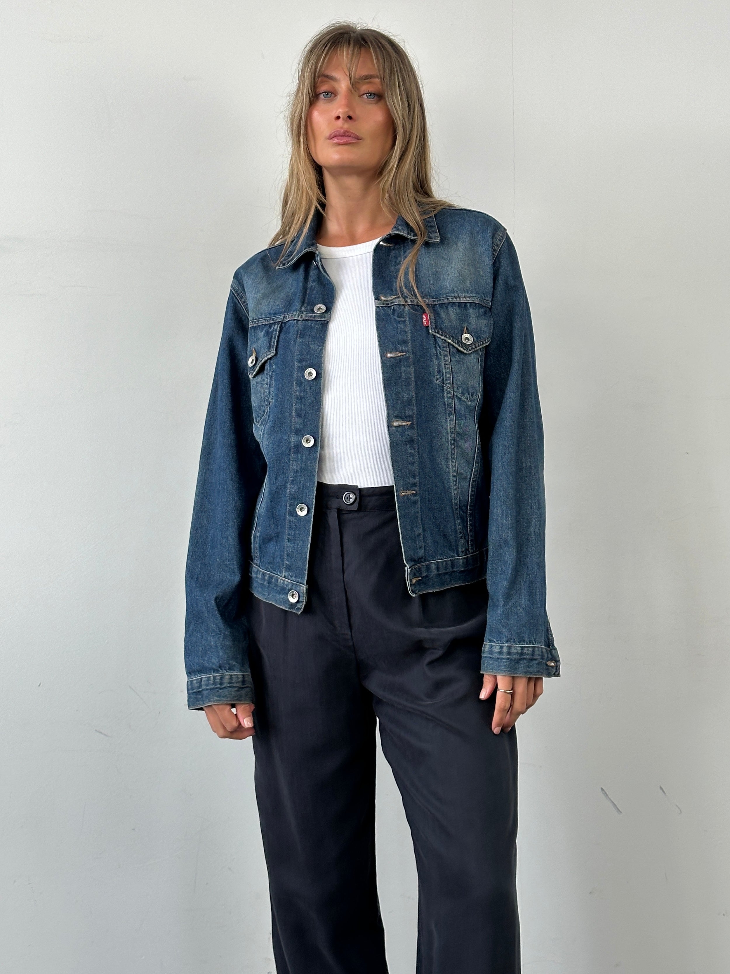 Levi’s faded denim jacket, size S, featuring classic style with distressed light wash fabric and button-front closure.