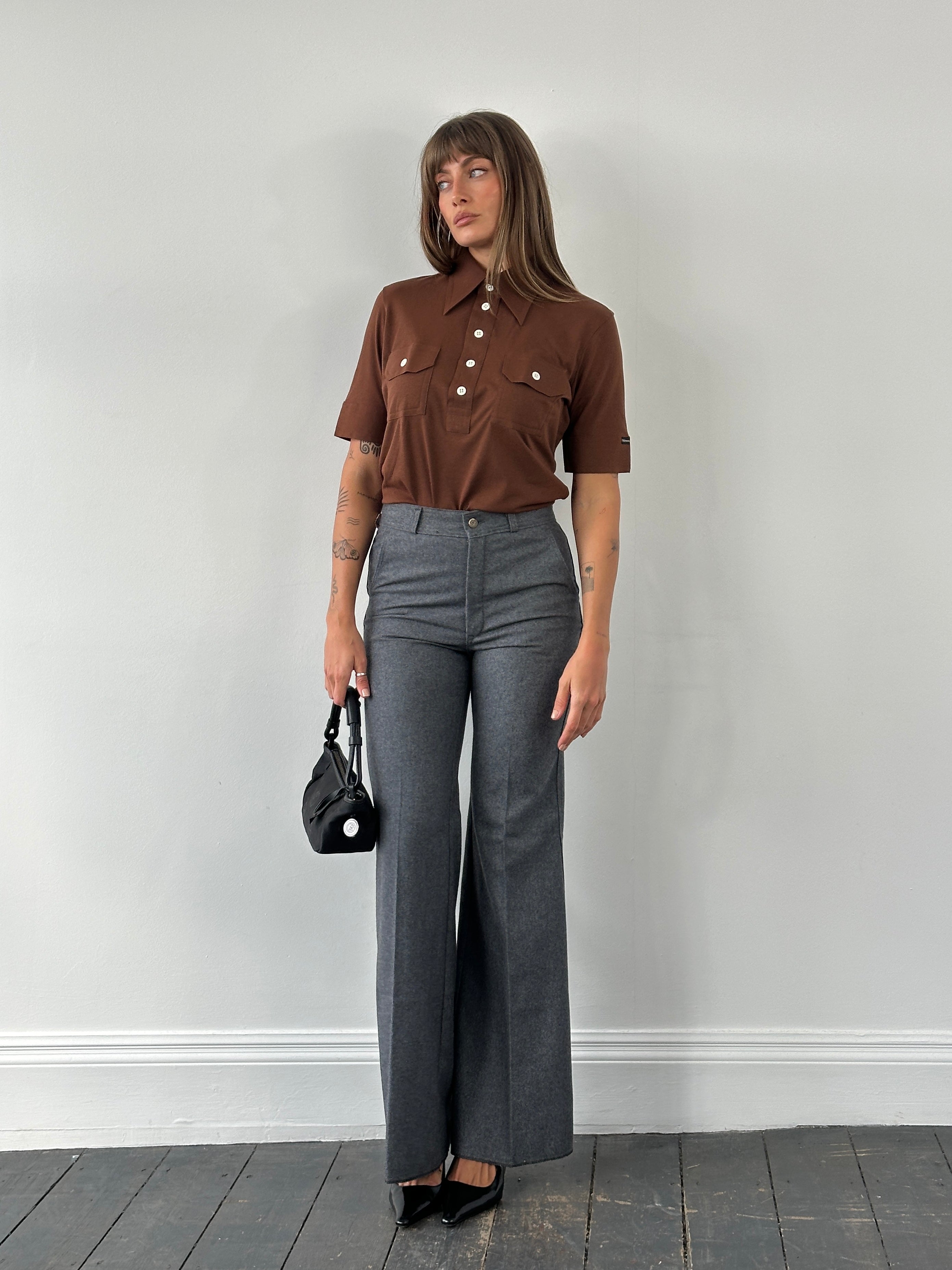 Vintage Italian 1970s wool flared tailored trousers in size W28, featuring classic high-waisted design and tailored fit.