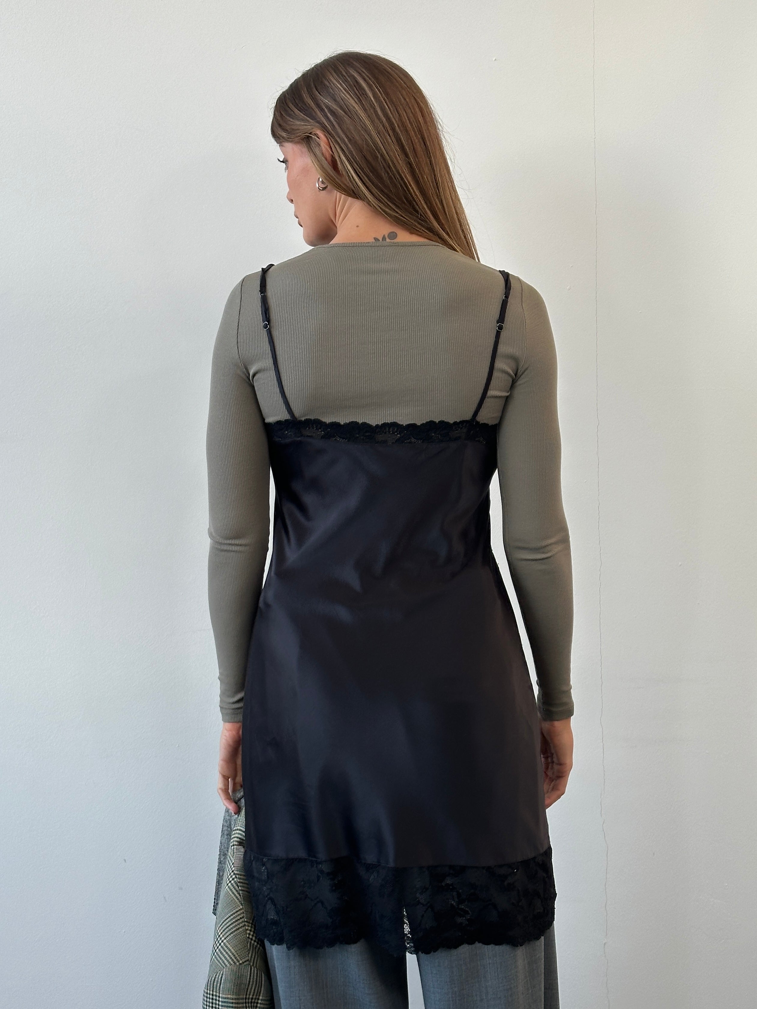 Vintage 1990s lace mini slip dress in black, featuring delicate lace details and a fitted silhouette, size M/L.