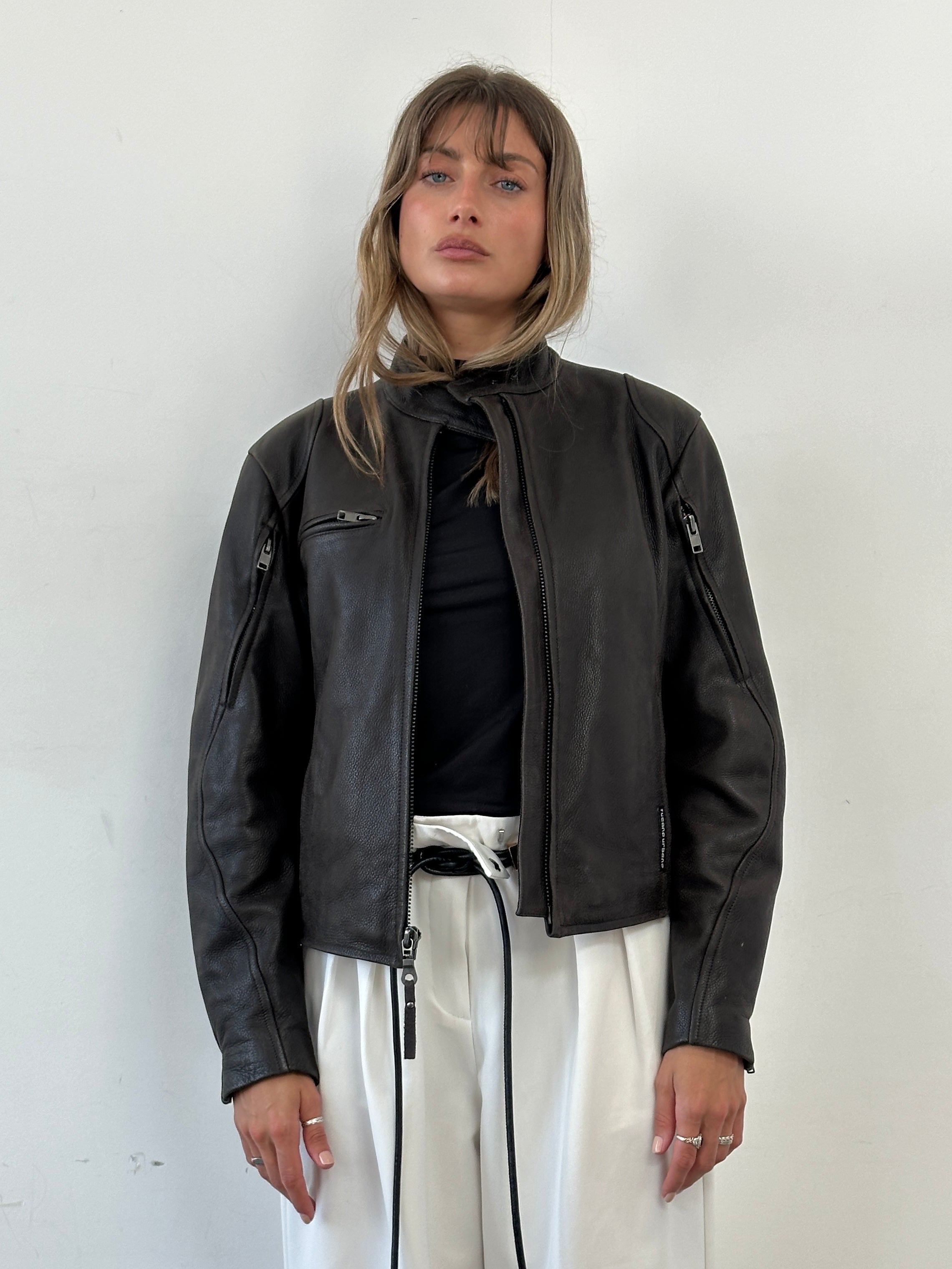 Vintage leather moto jacket in size small/medium, featuring classic design, metallic zippers, and a distressed brown finish.