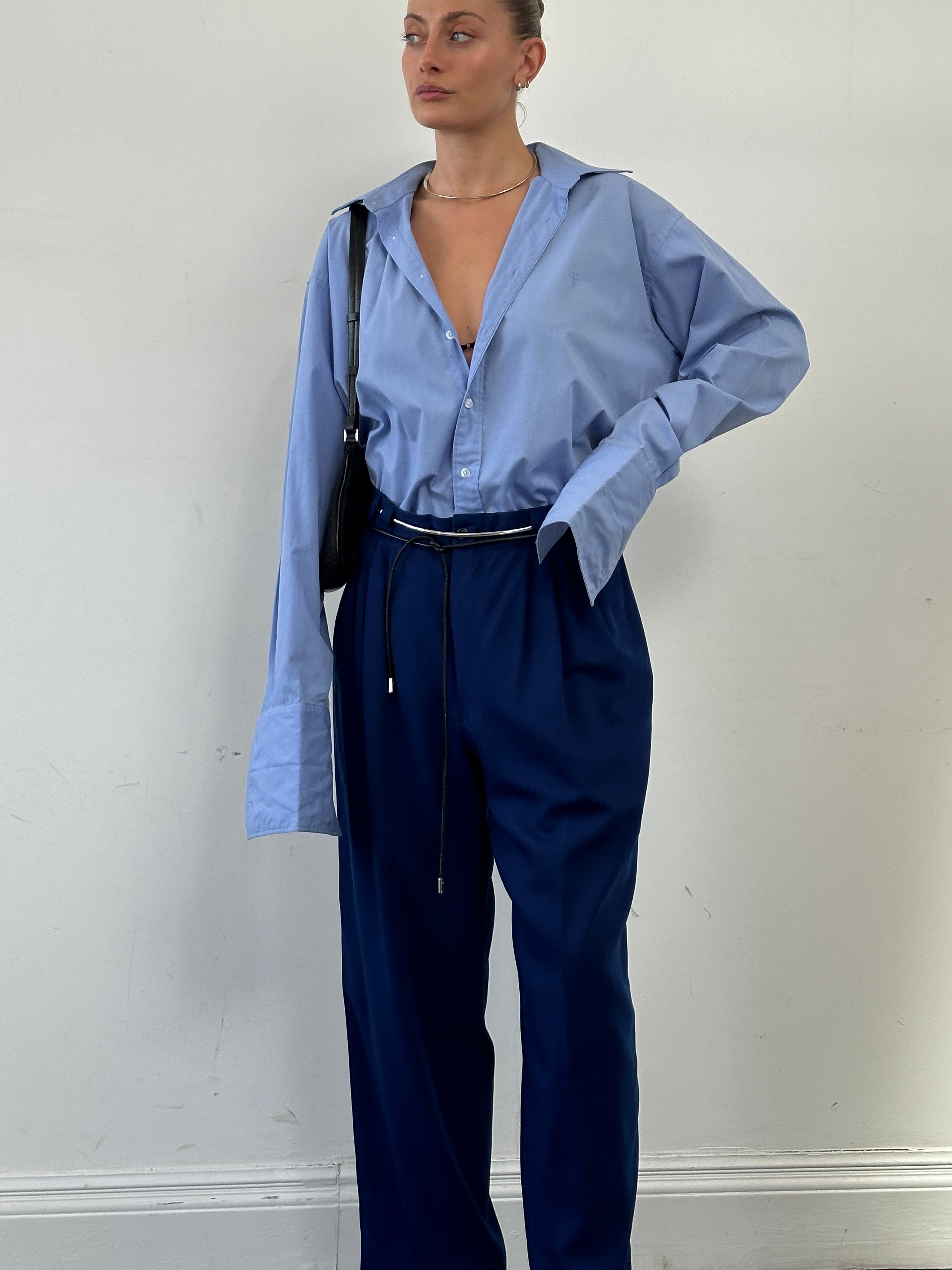 Versace Classic V2 wool pleated high-waisted tailored trousers in dark fabric, front view showing pleats and tailored fit.