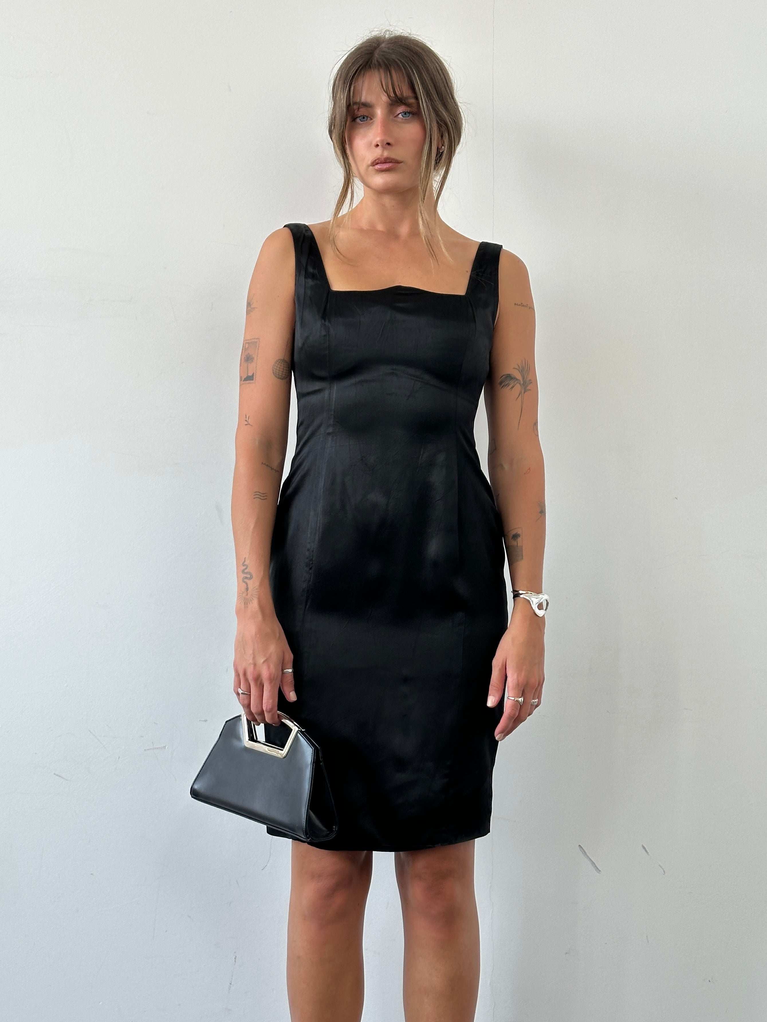 Vintage leather crossbody clutch bag with chrome accents, stylish and compact for everyday use.