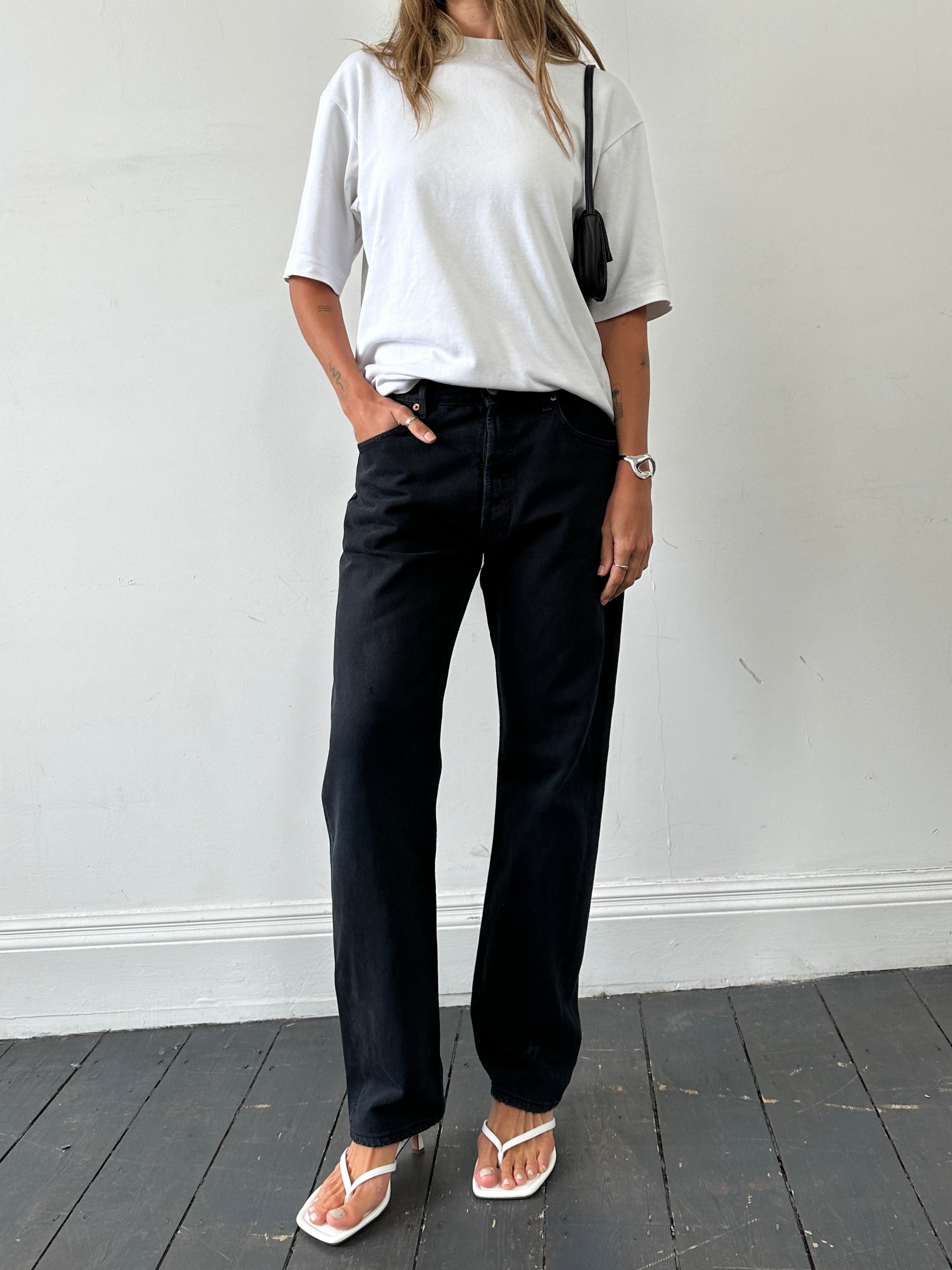 Levi’s 501 straight-leg high-waisted denim jeans in W32, showing classic blue color and traditional five-pocket design.