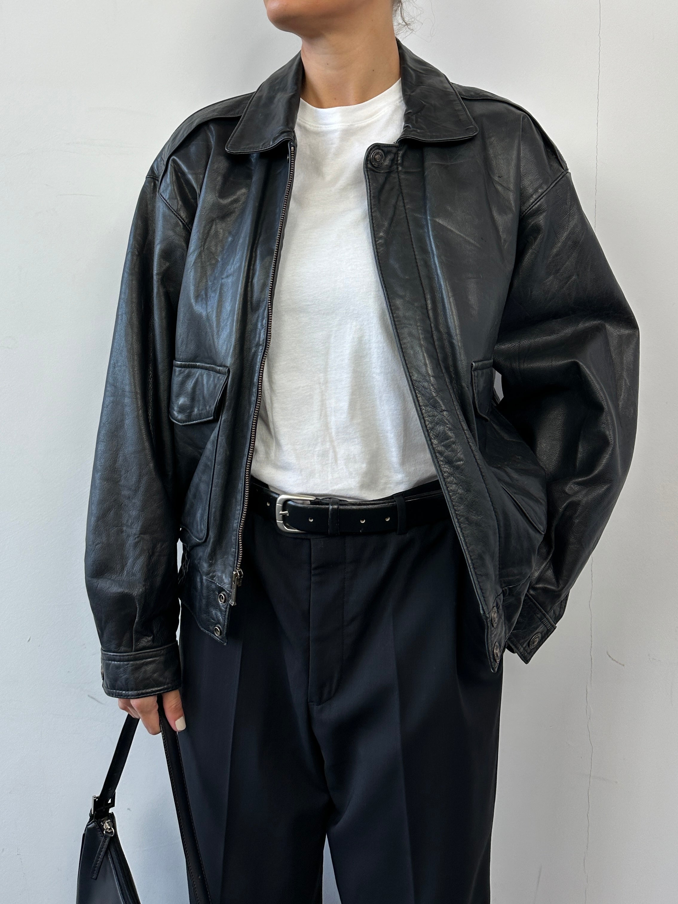 Vintage leather bomber jacket in size S/M, featuring classic design with smooth leather and ribbed collar and cuffs.