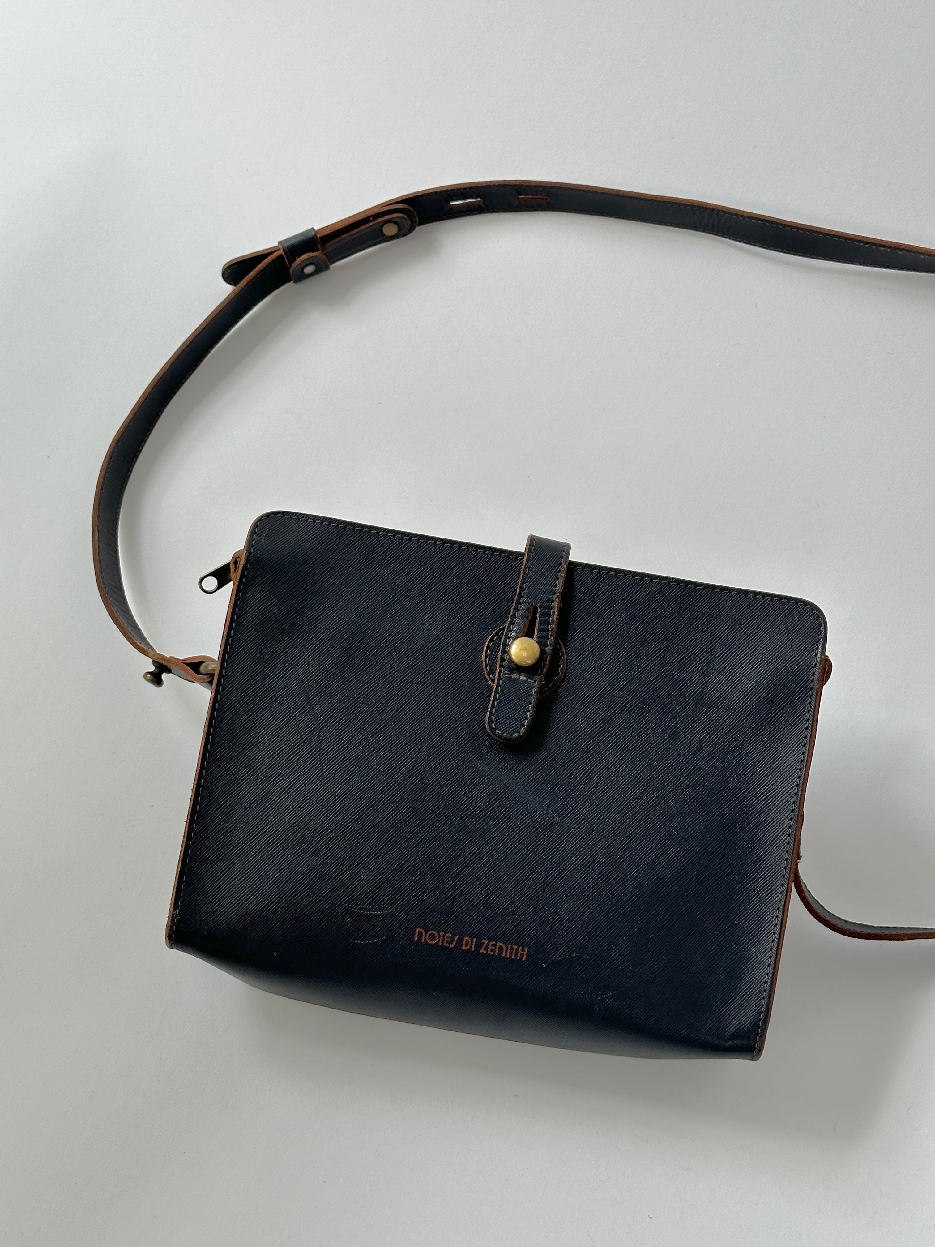 Vintage leather crossbody bag with adjustable strap and classic design, featuring a textured brown finish.