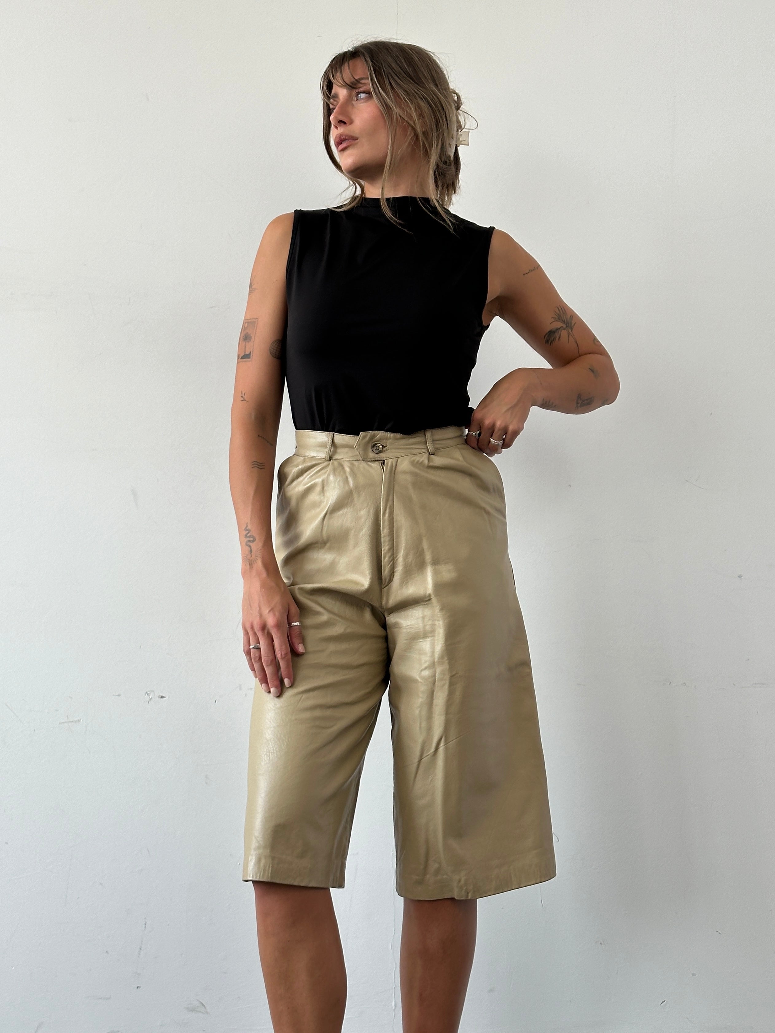 Vintage leather wide-leg high-waisted long shorts, styled with a vintage aesthetic, featuring a rich leather texture and wide leg design.