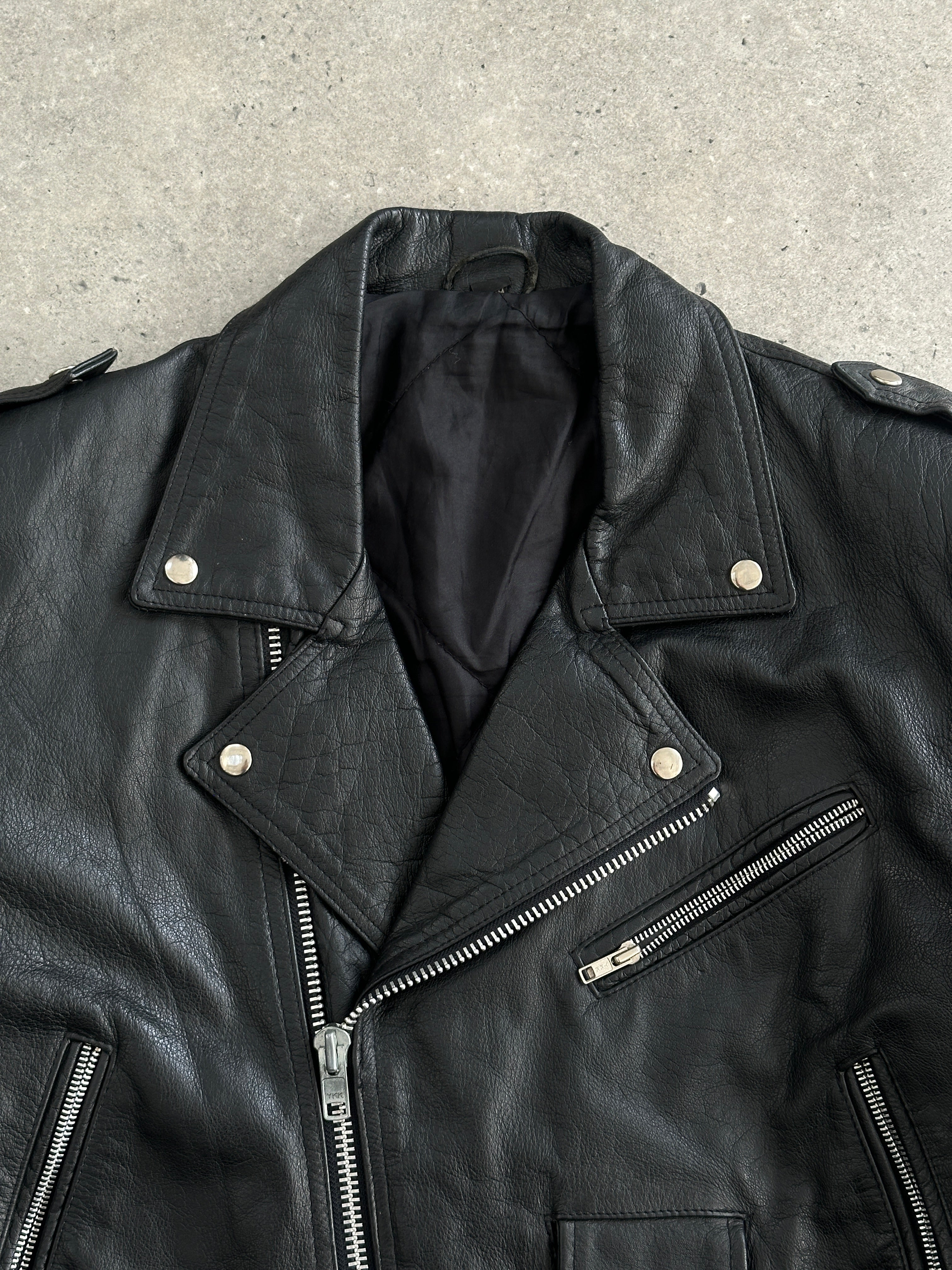 Vintage 1990s leather biker jacket in size large, featuring classic distressed leather and authentic vintage styling.