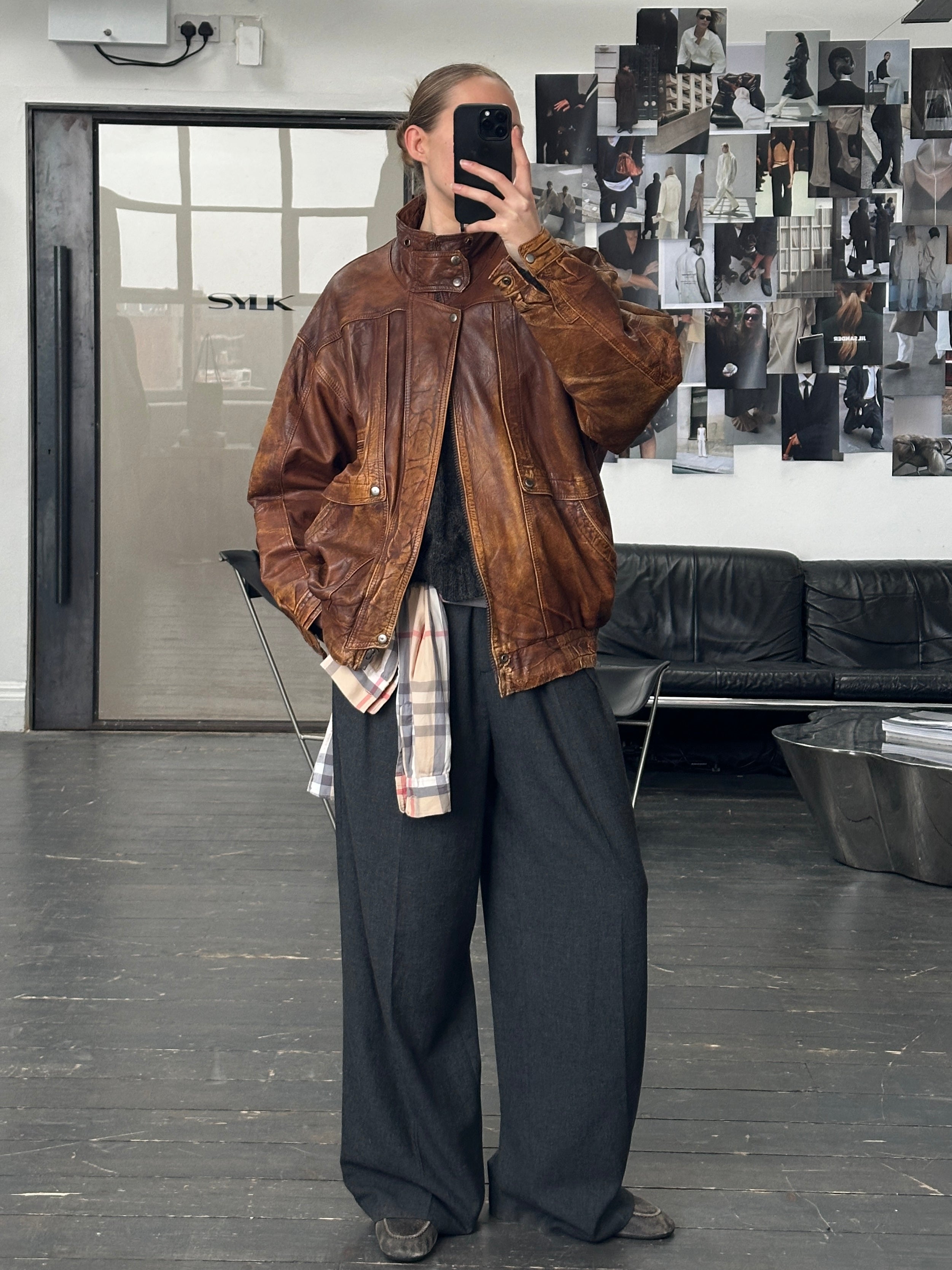 Vintage 1990s aged leather bomber jacket in XL, featuring classic design and distressed leather texture.