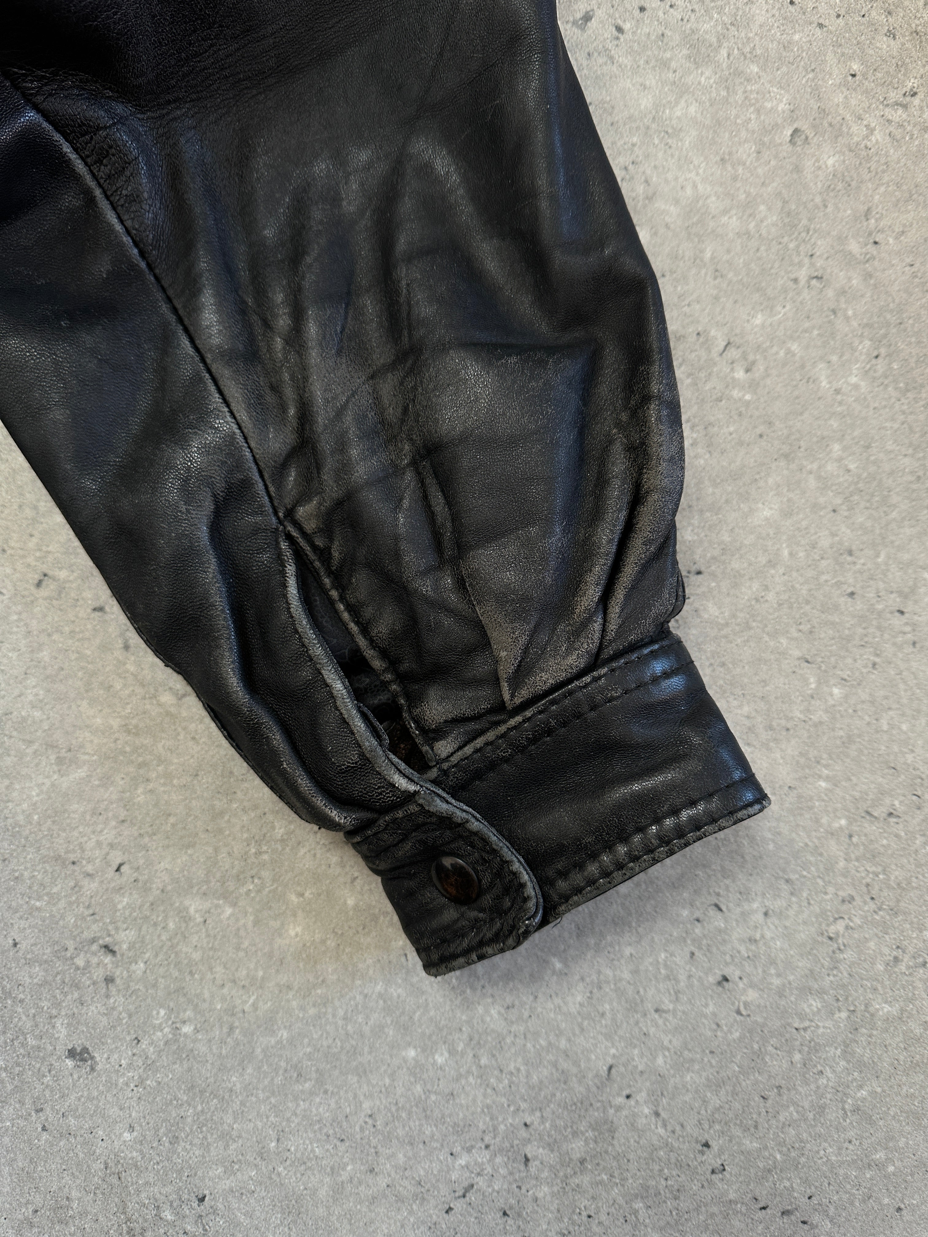 Vintage Leather Bomber Jacket in size M, featuring classic design, smooth leather exterior, and ribbed collar and cuffs.