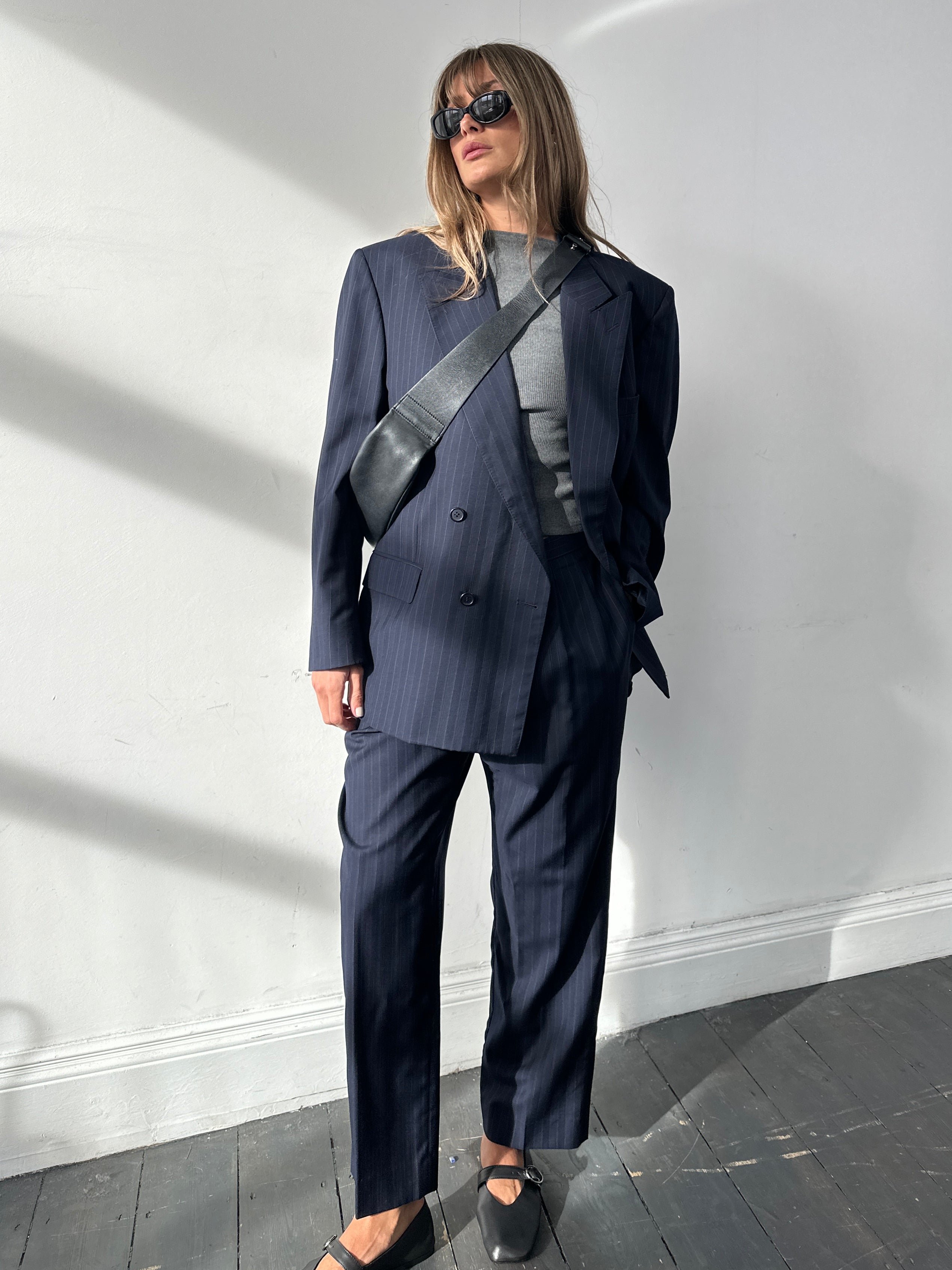 Christian Dior Monsieur pinstripe wool double-breasted suit, size 44S/W34, tailored jumpsuit with classic suit details and sharp pinstripe pattern.