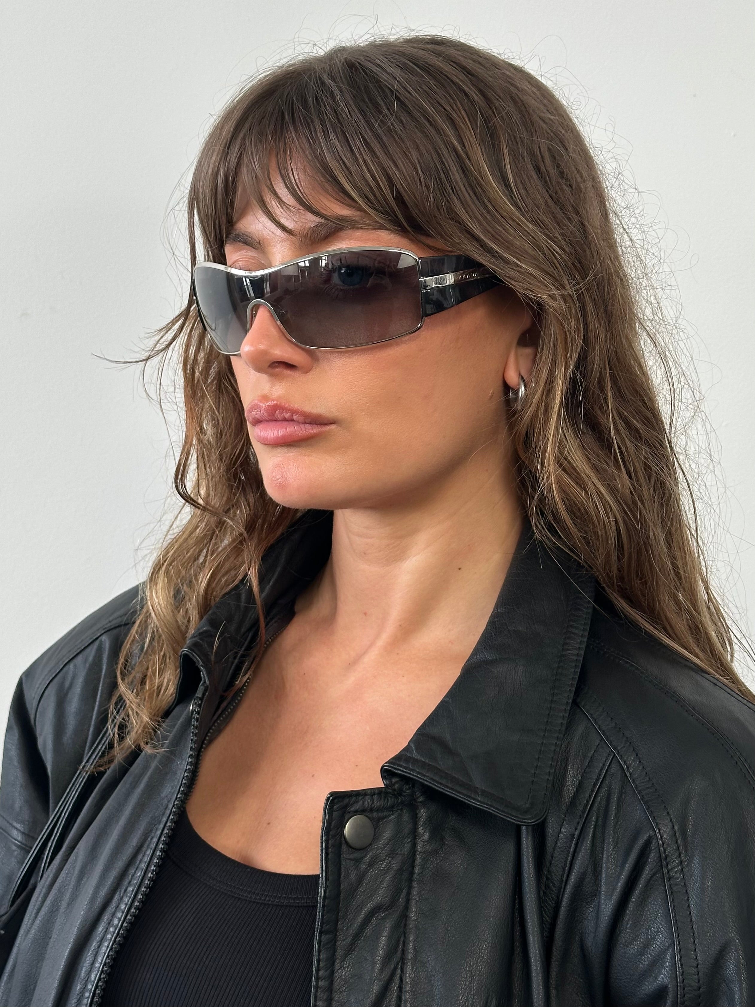 Prada 2000s aviator shield sunglasses with large dark lenses and metallic frame, stylish and iconic eyewear.