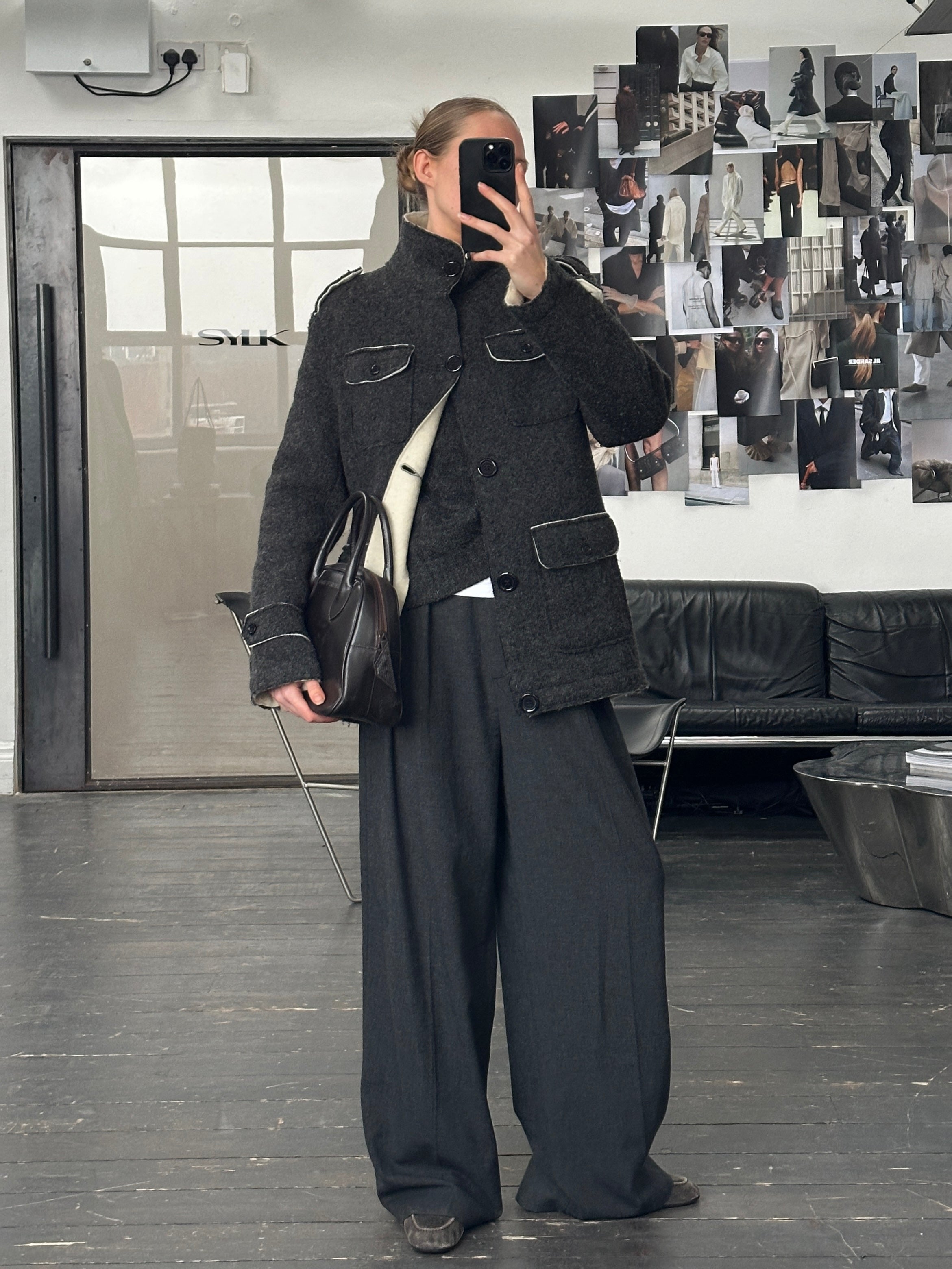Vintage 1990s wool high neck utility jacket in size L, featuring a classic design and durable fabric, displayed on a hanger.