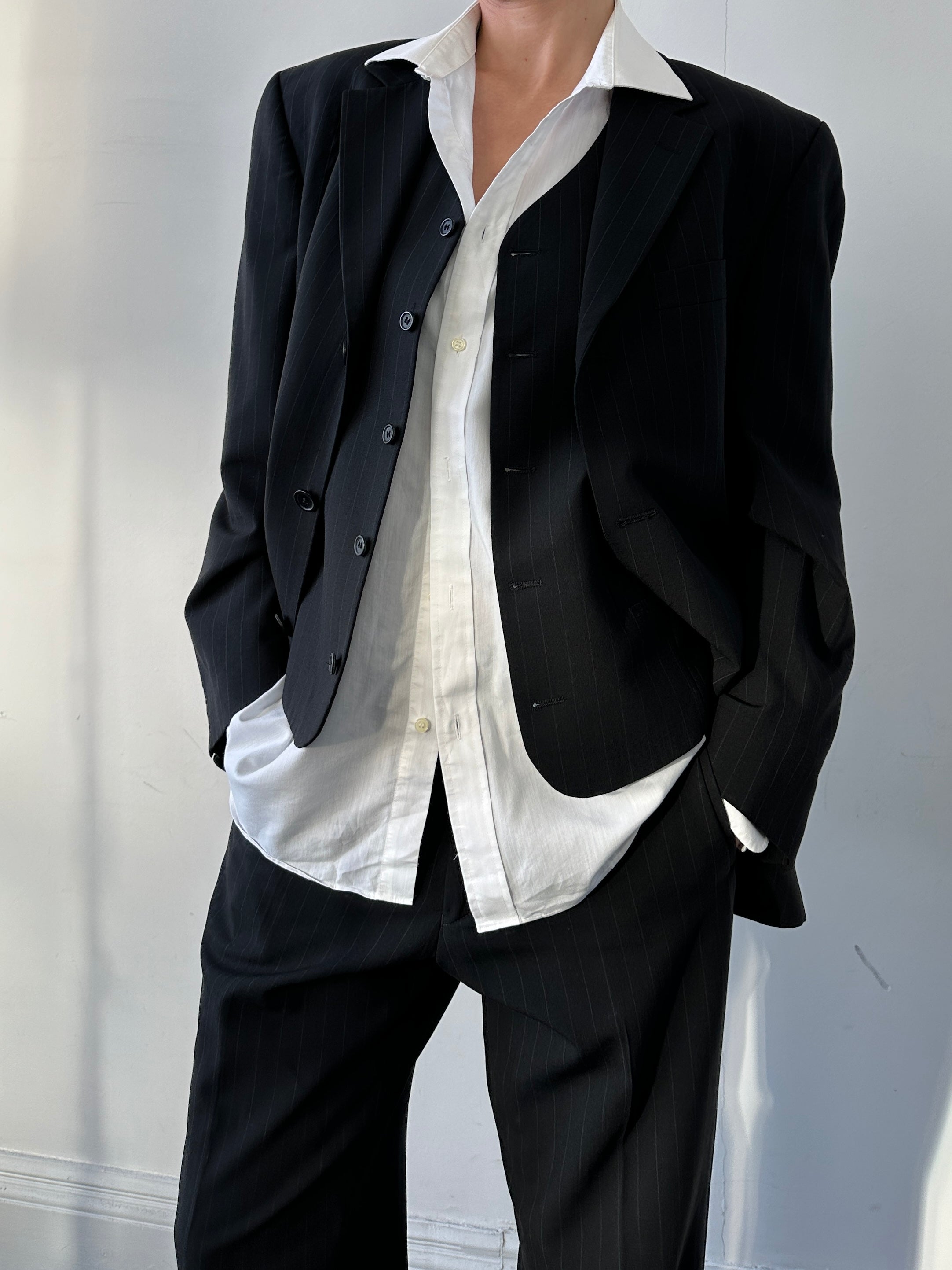 Vintage pinstripe wool three-piece suit in size 40R/W32, featuring jacket, vest, and trousers displayed on a mannequin.