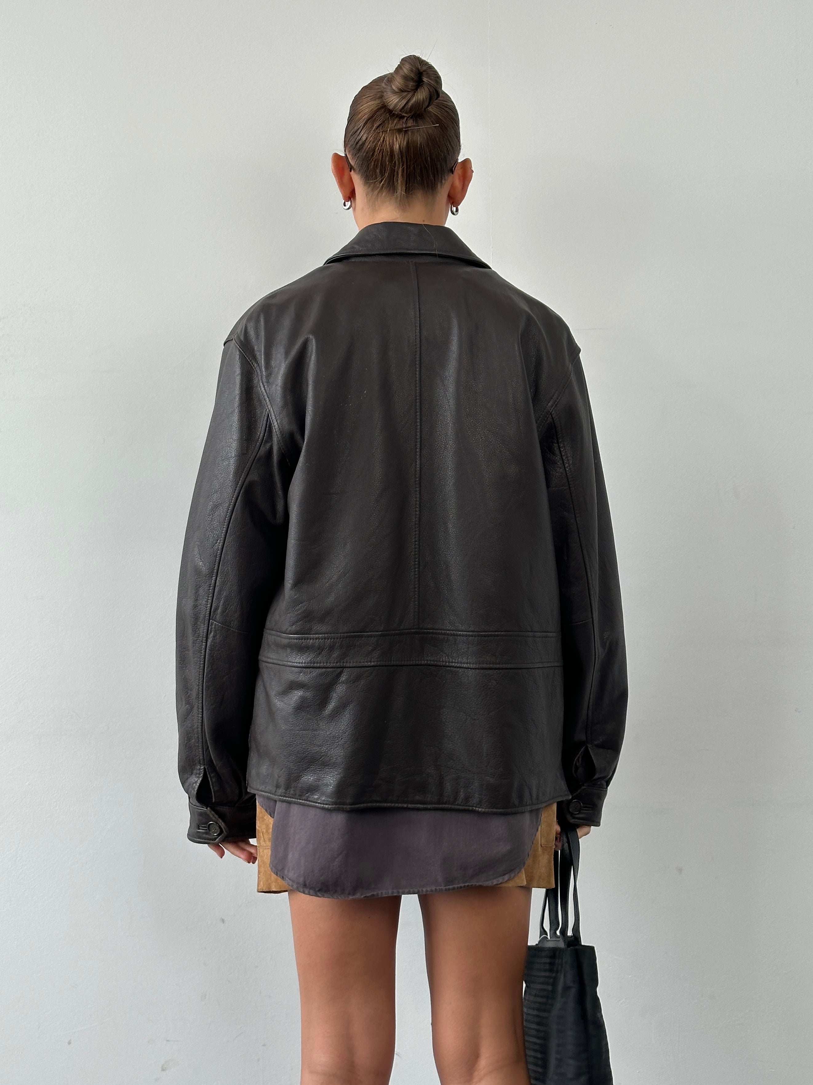 Vintage boxy leather jacket in size L, featuring a classic design with a structured fit and smooth leather texture.