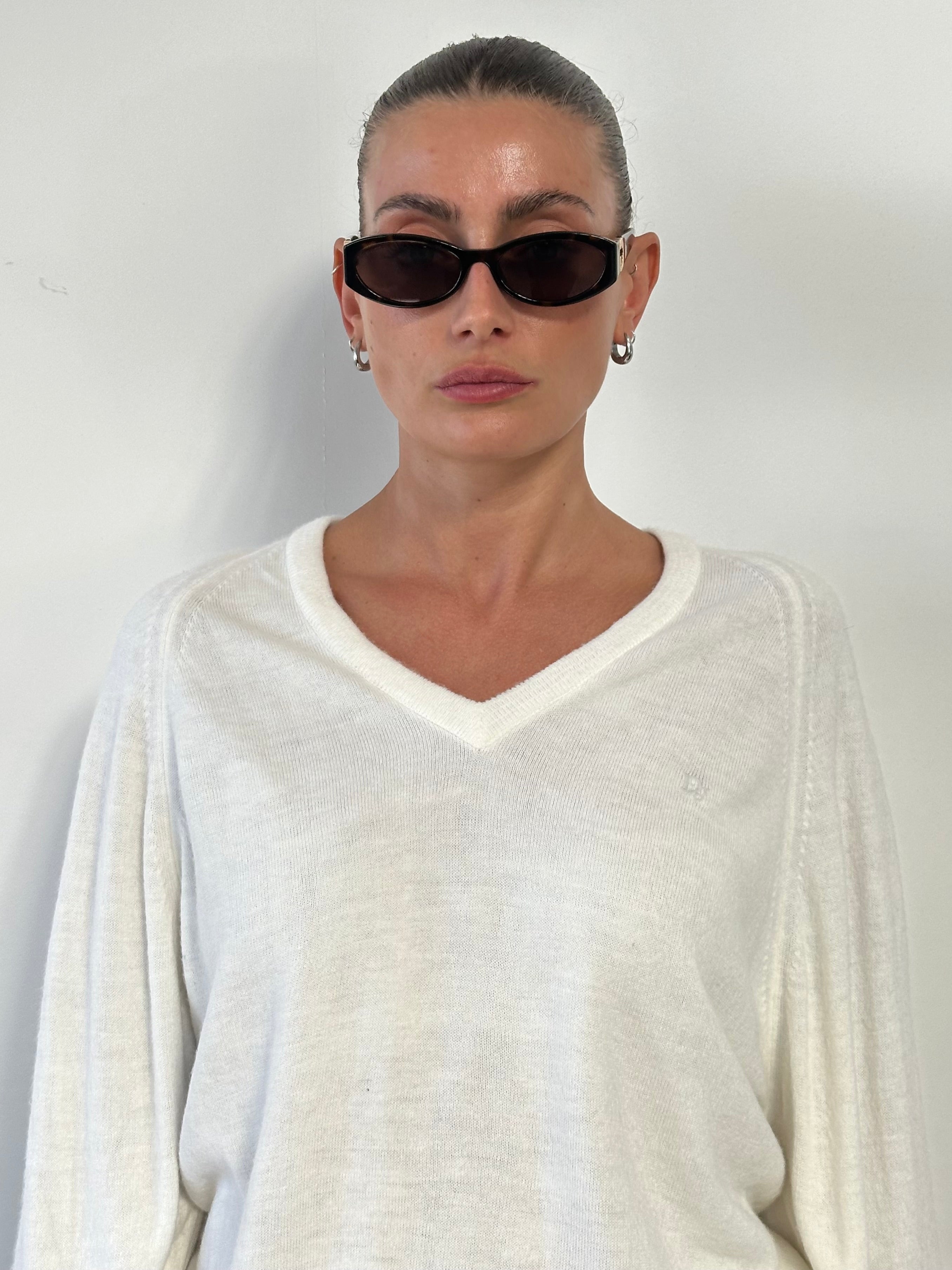 Christian Dior V neck logo knitted jumper in size L, featuring a classic design with the Dior branding and a comfortable fit.