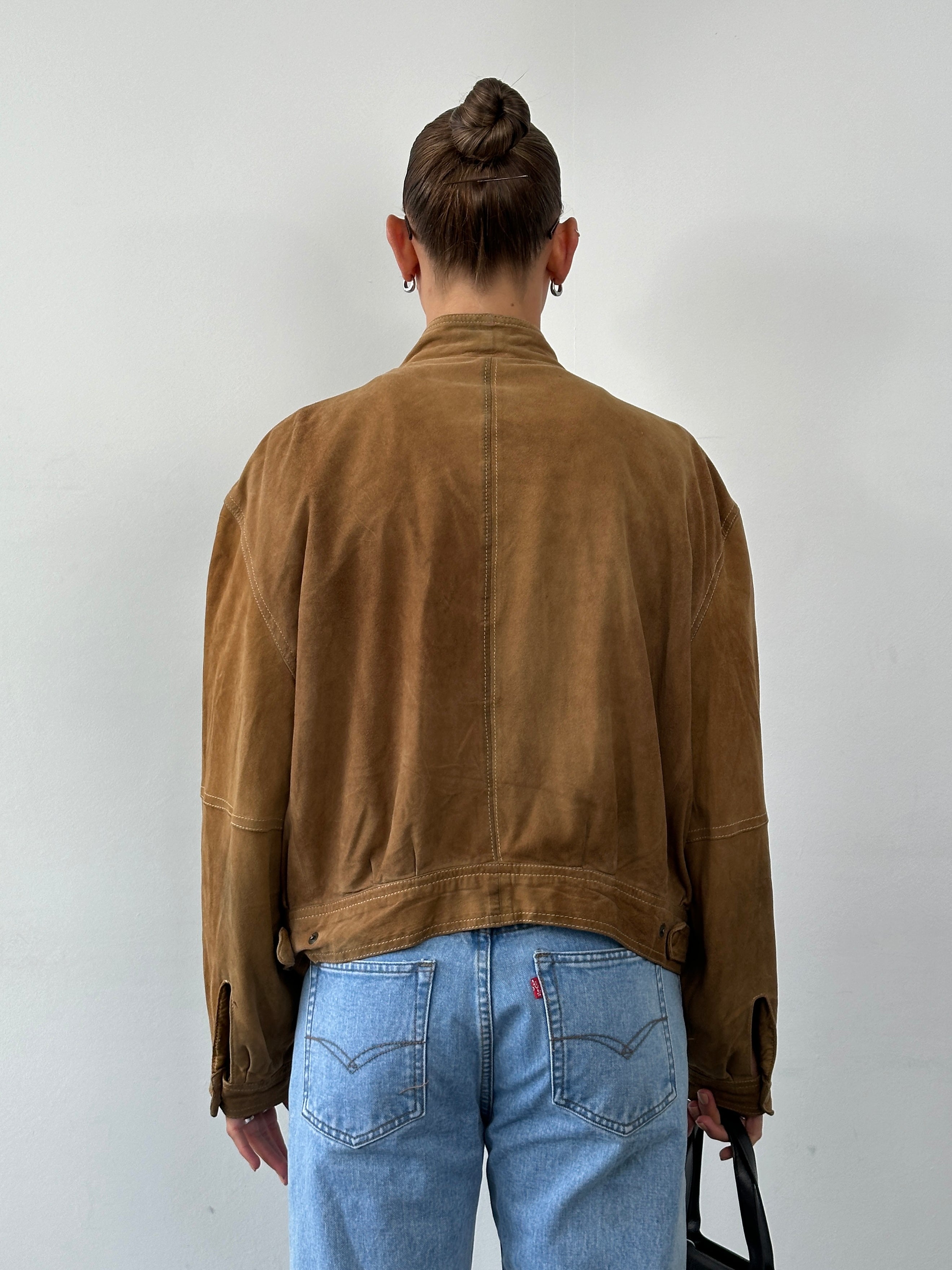 Vintage high neck suede bomber jacket in size M with classic design and soft texture, shown on a hanger.