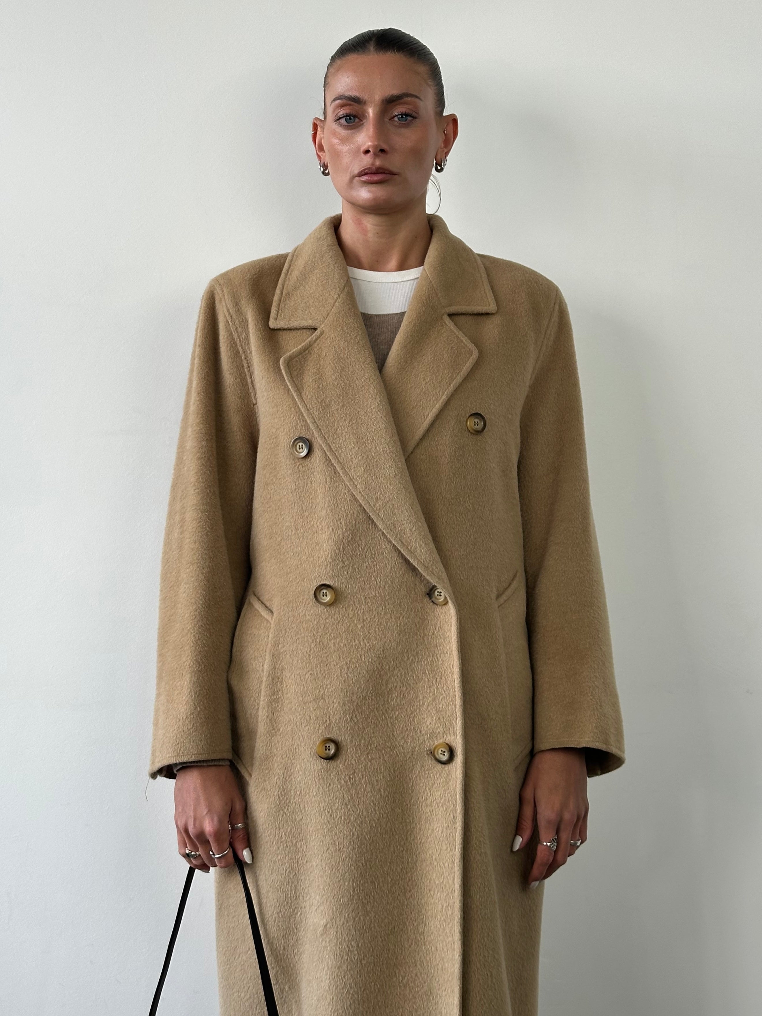 Max Mara wool camel hair double-breasted coat in size M/L, shown hanging with classic lapels and tailored fit.