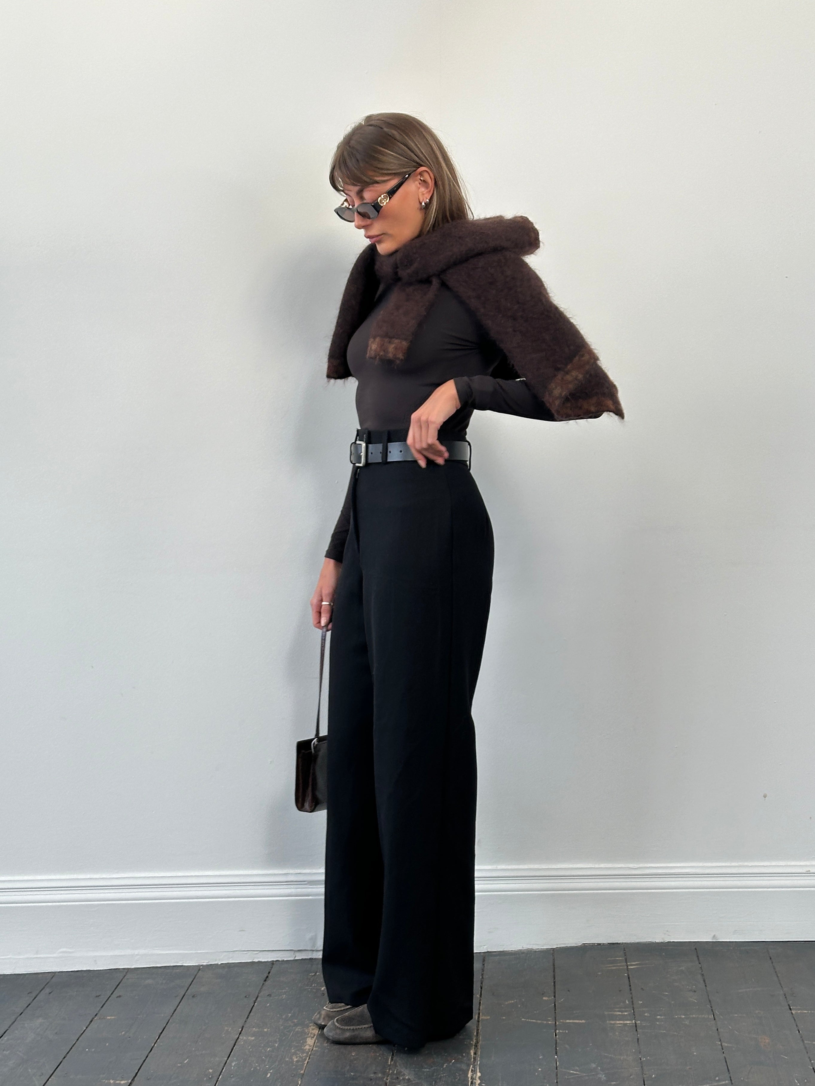 Vintage 1990s pure wool wide leg tailored trousers in size W26, featuring a classic high waist and wide-leg silhouette.