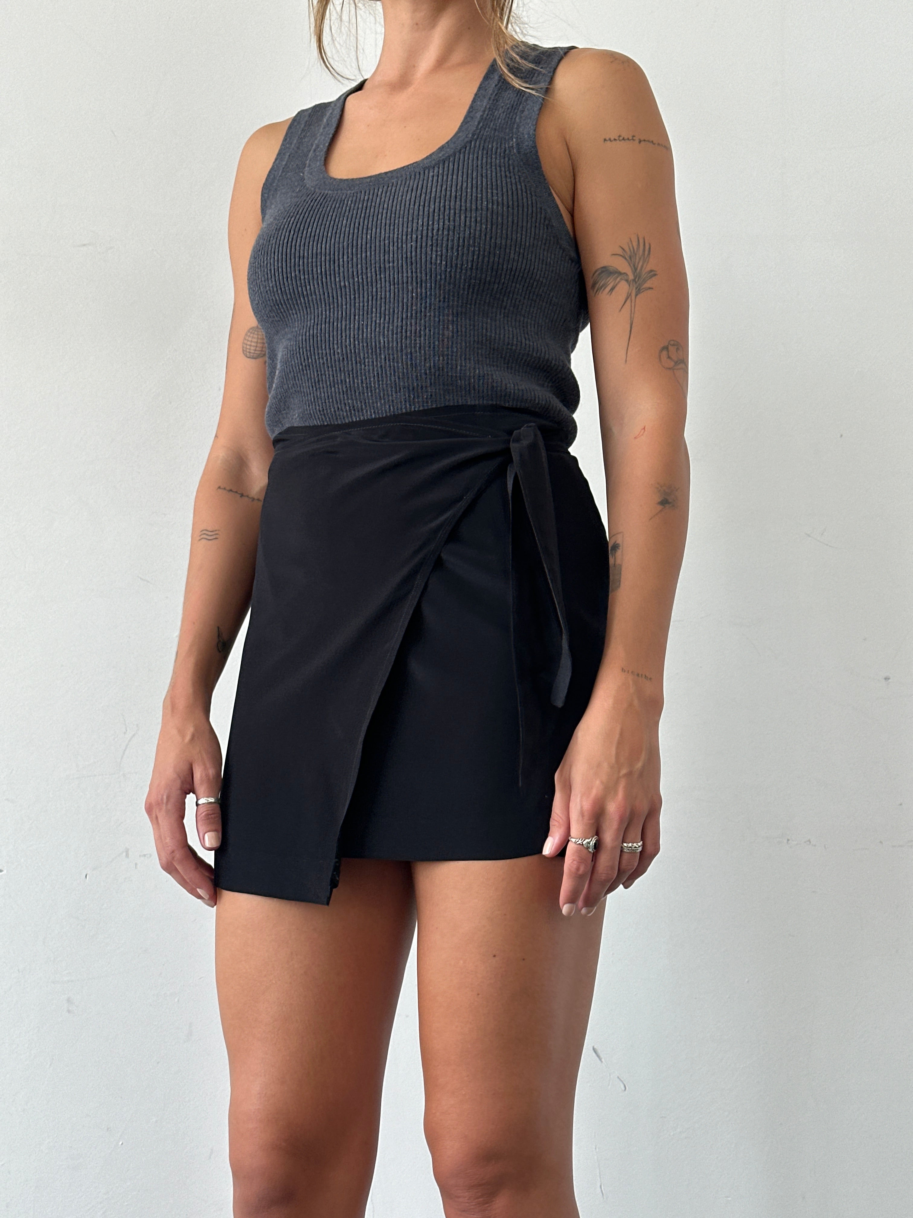 Vintage mini wrap skirt in classic style, featuring a fitted waist and flowing hem, perfect for casual or chic outfits.