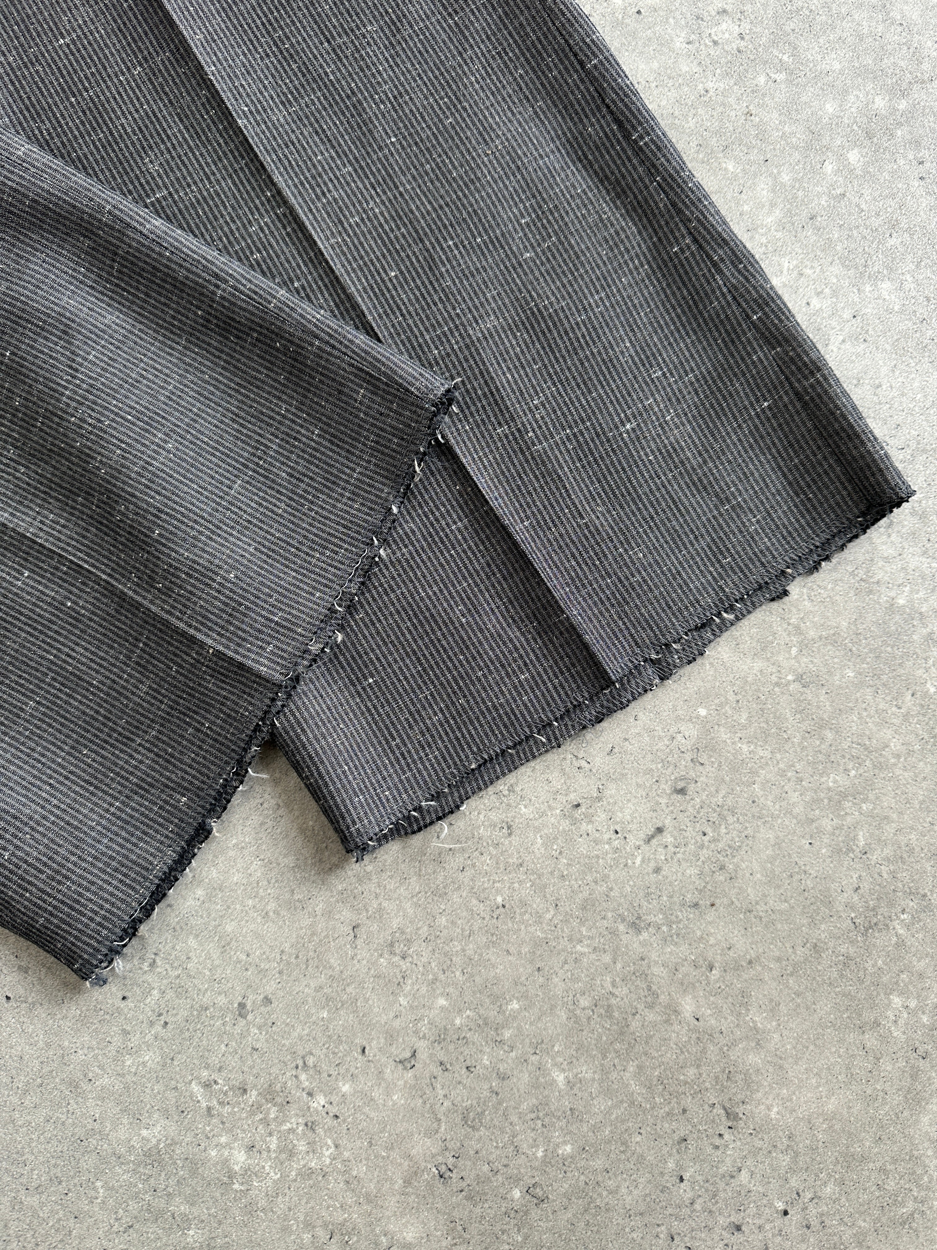 Vintage Italian high-waisted tailored trousers with straight leg fit, raw hem, and W28 size, styled in a classic vintage look.