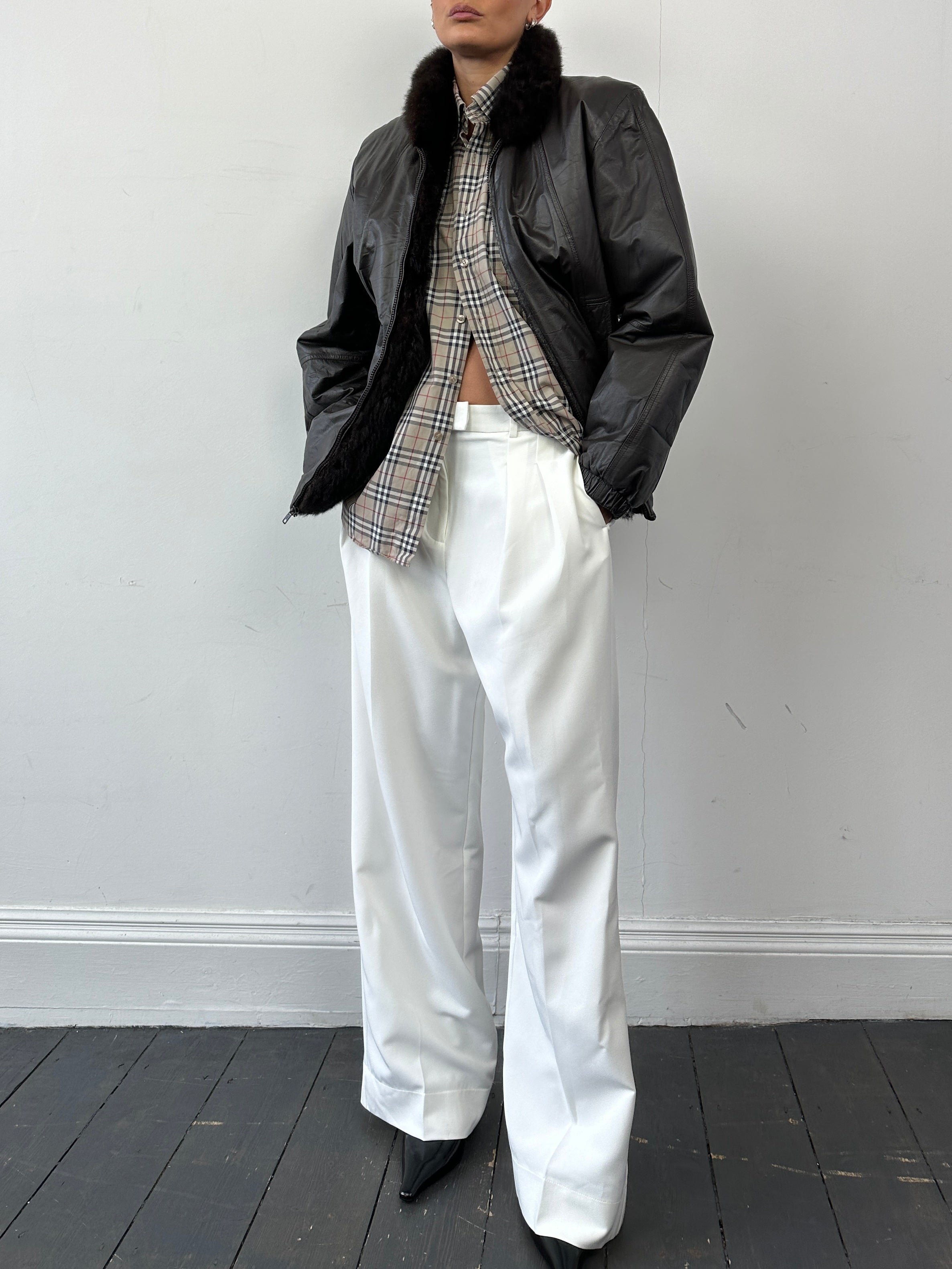 Vintage faux fur-lined leather bomber jacket in size small, featuring minimal design and classic style.