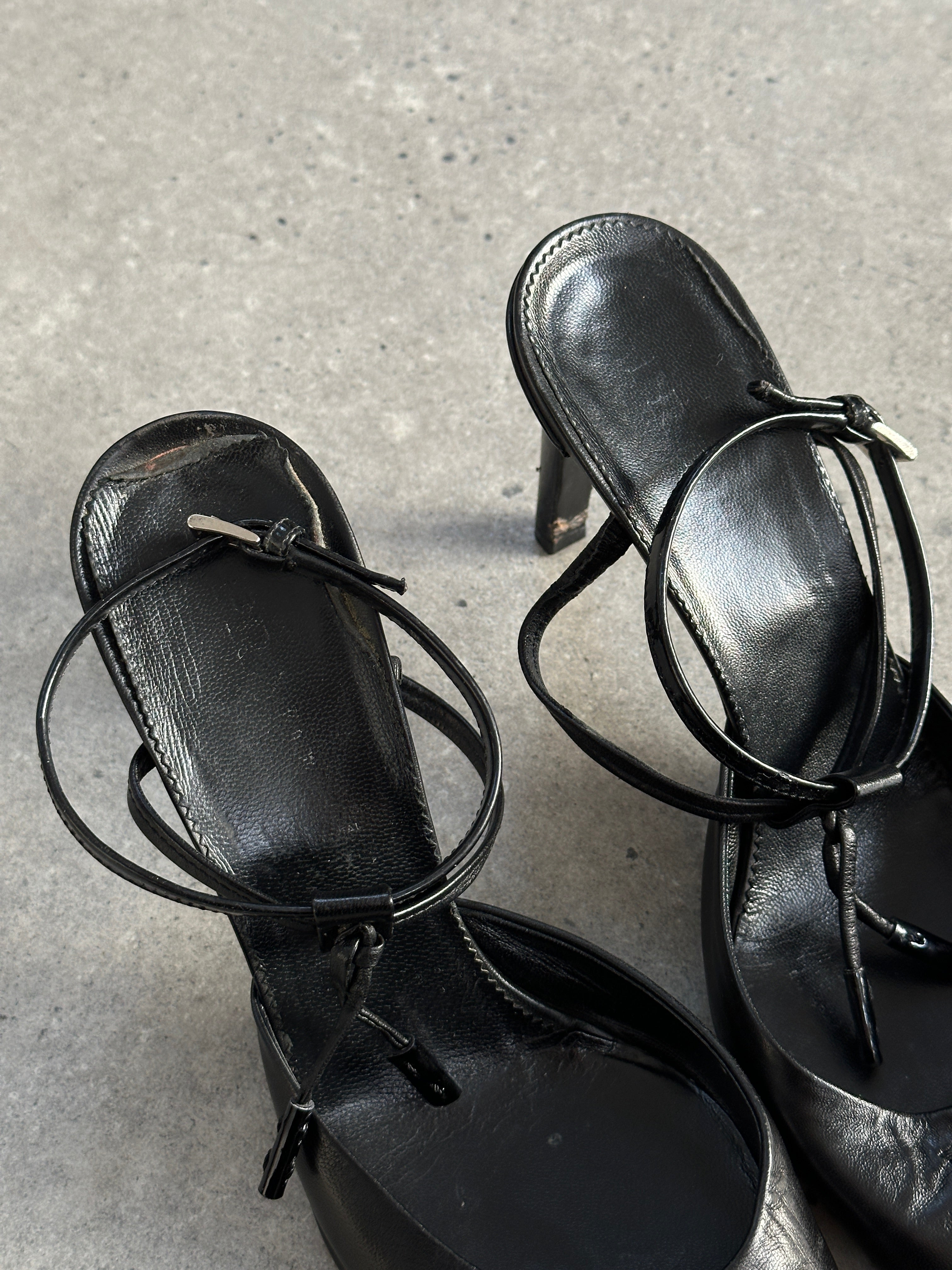 Prada pointed toe high heels in black leather, UK size 7.5, showcasing sleek design and elegant heel detail.