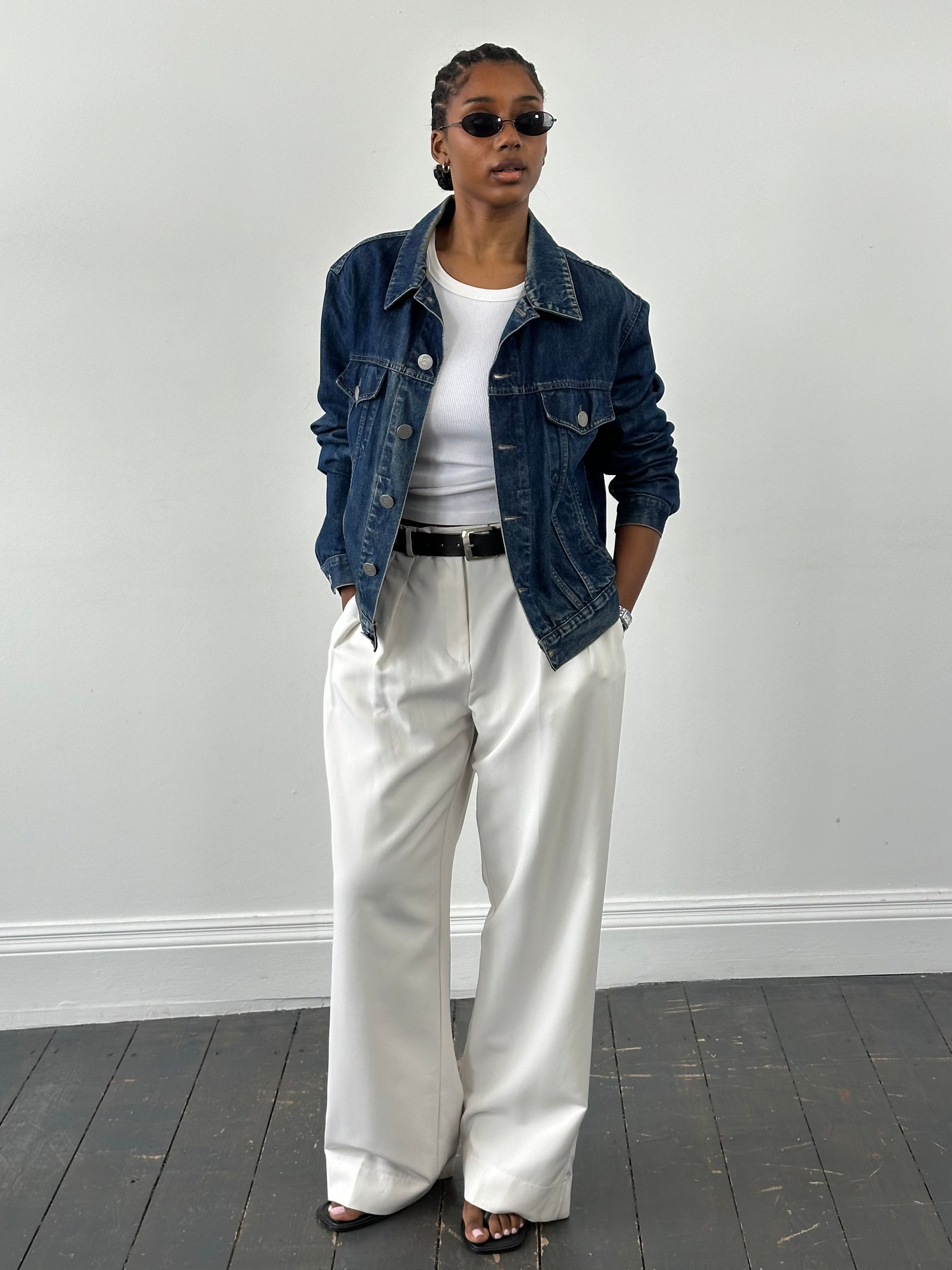 Armani Jeans 1900s mid-wash denim jacket, casual fit, classic design, shown hanging on a wooden hanger.