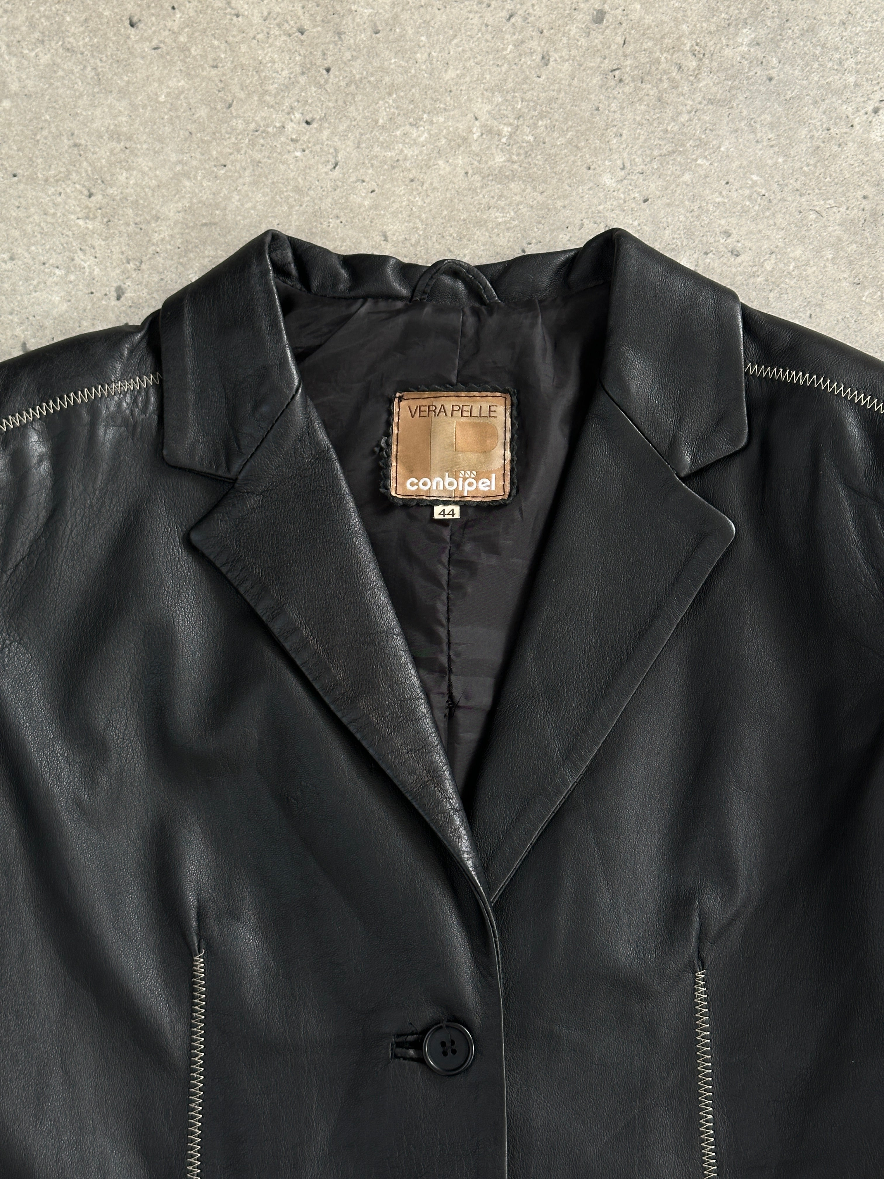 Conbipel single-breasted leather blazer jacket in black, tailored fit, featuring lapels and button closure, worn casually.