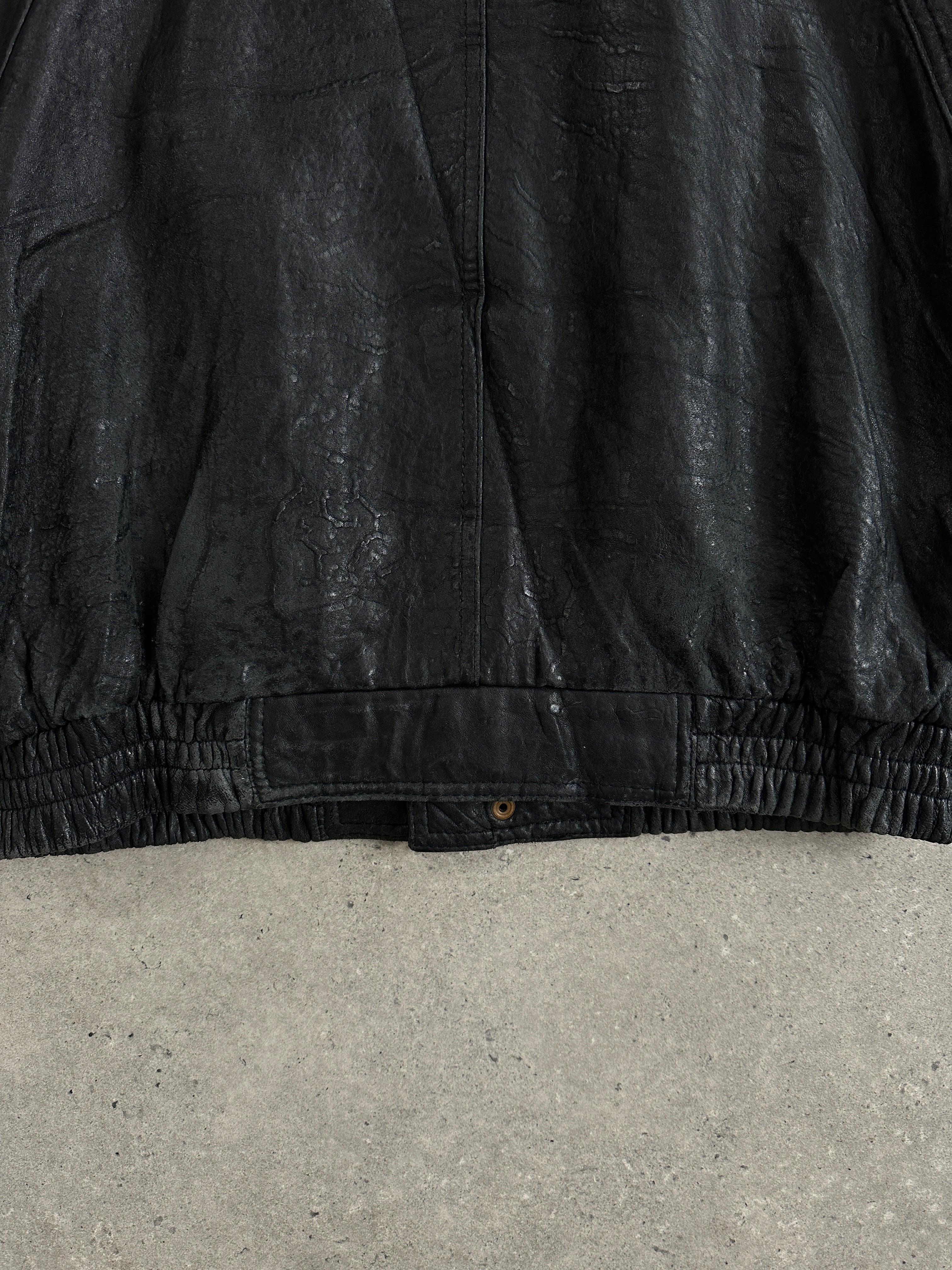 Vintage distressed leather bomber jacket in size L, featuring rugged texture and classic style, shown on a hanger.