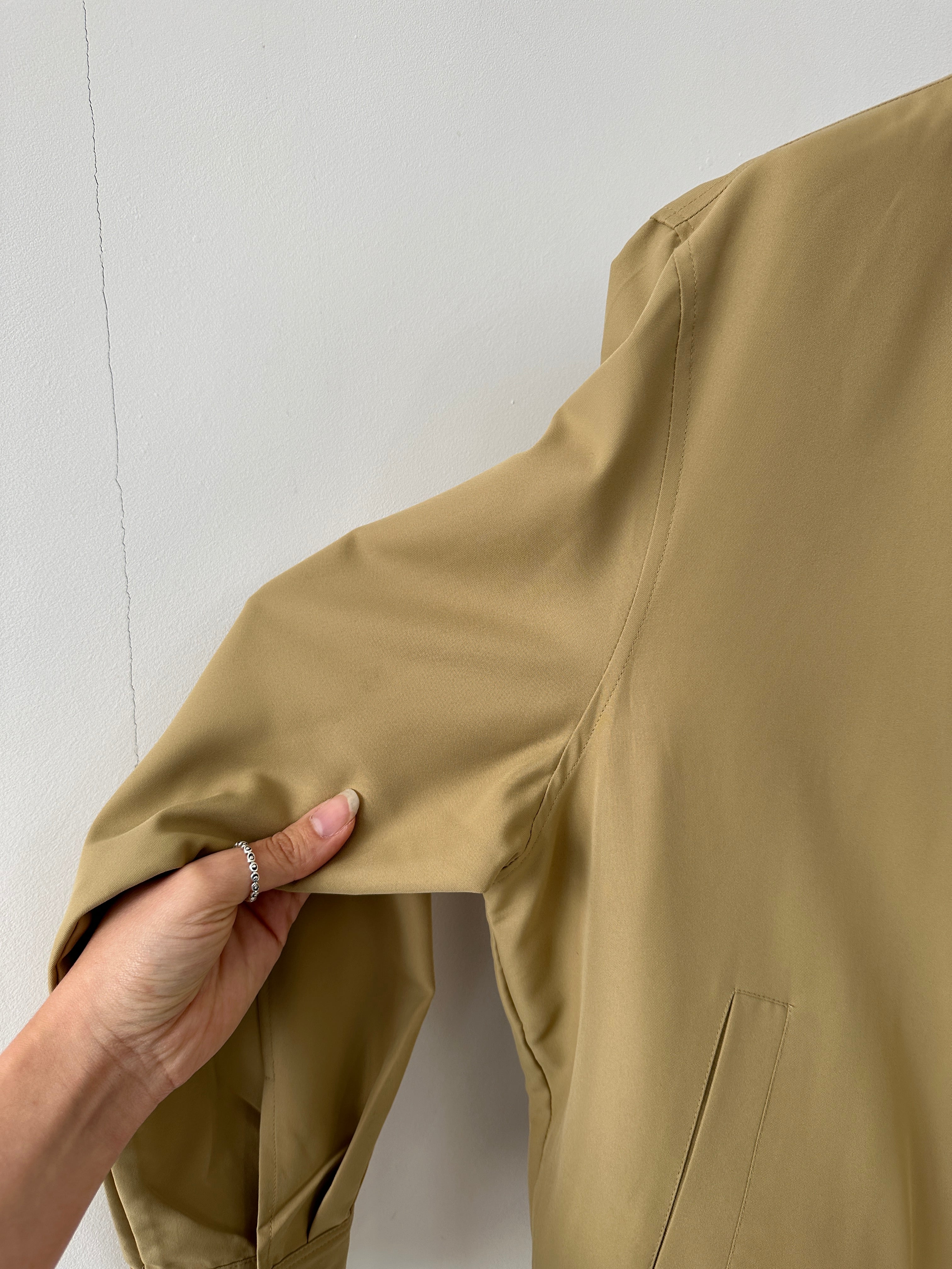 Yves Saint Laurent logo bomber jacket in black, featuring ribbed cuffs and collar, displayed on a hanger.