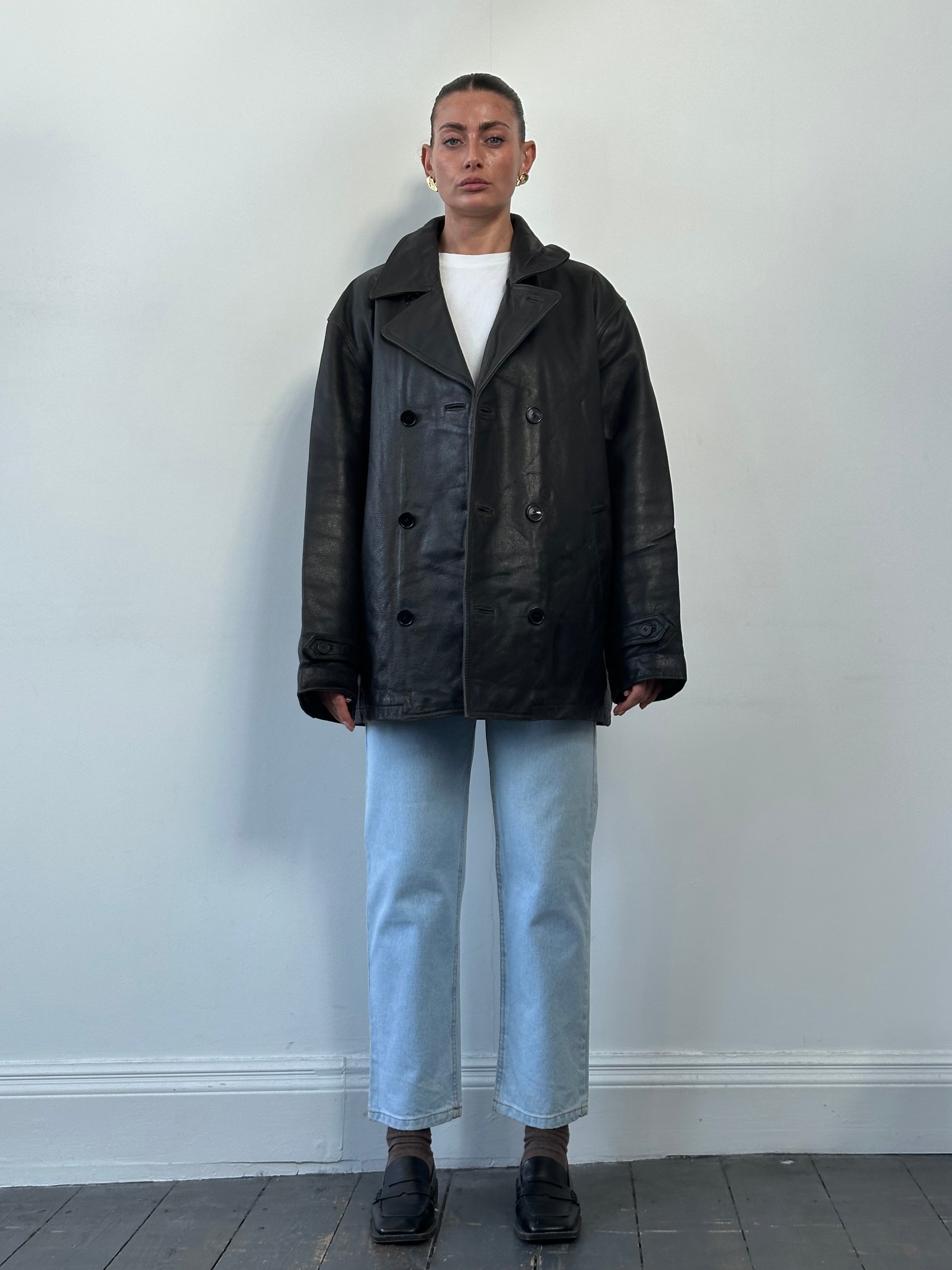 Tommy Hilfiger double-breasted leather jacket in XL displayed on a hanger, featuring classic design and rich brown leather.