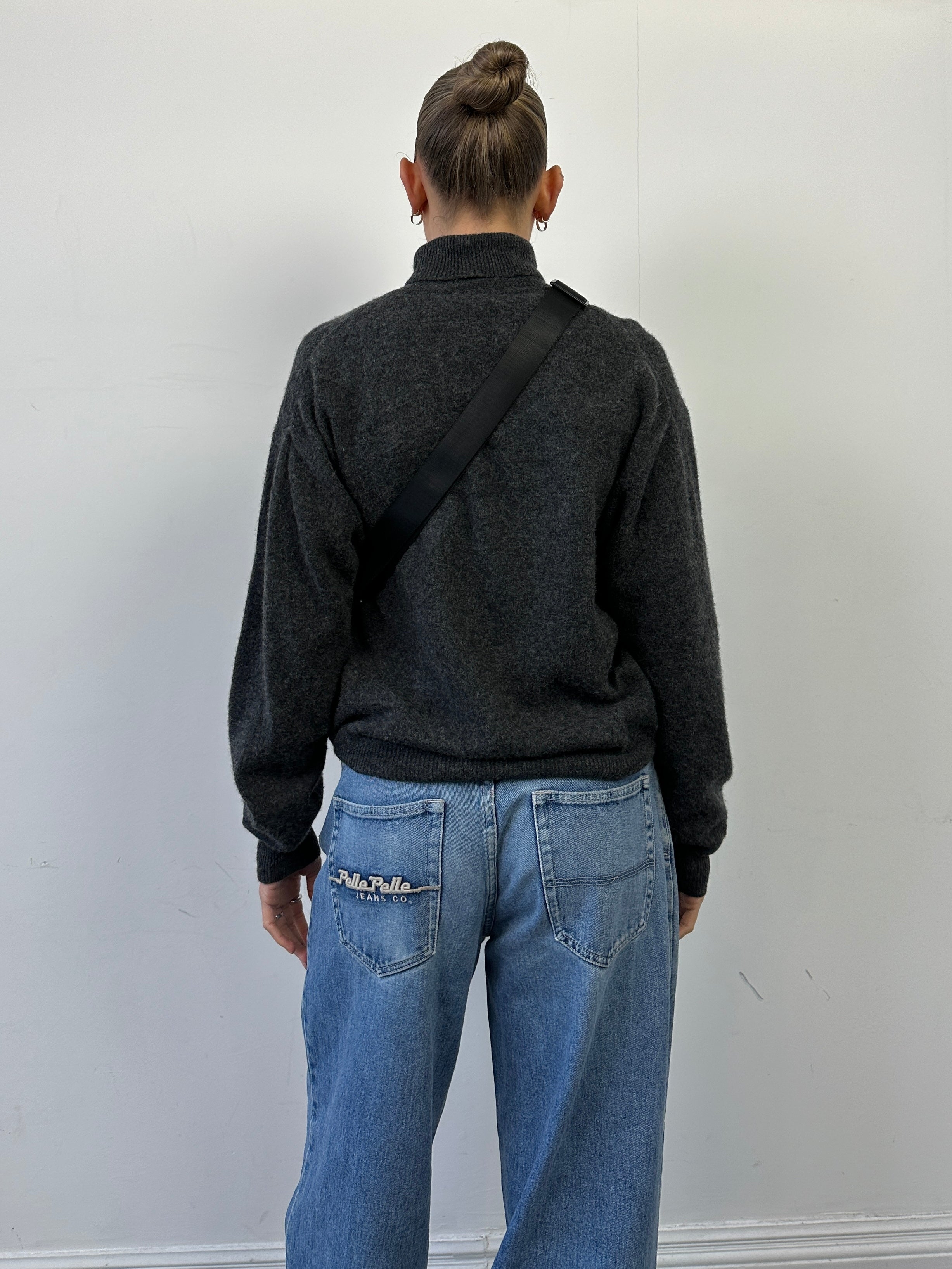 Lacoste pure wool roll neck jumper in gray, featuring a classic fit and ribbed collar, displayed on a neutral background.