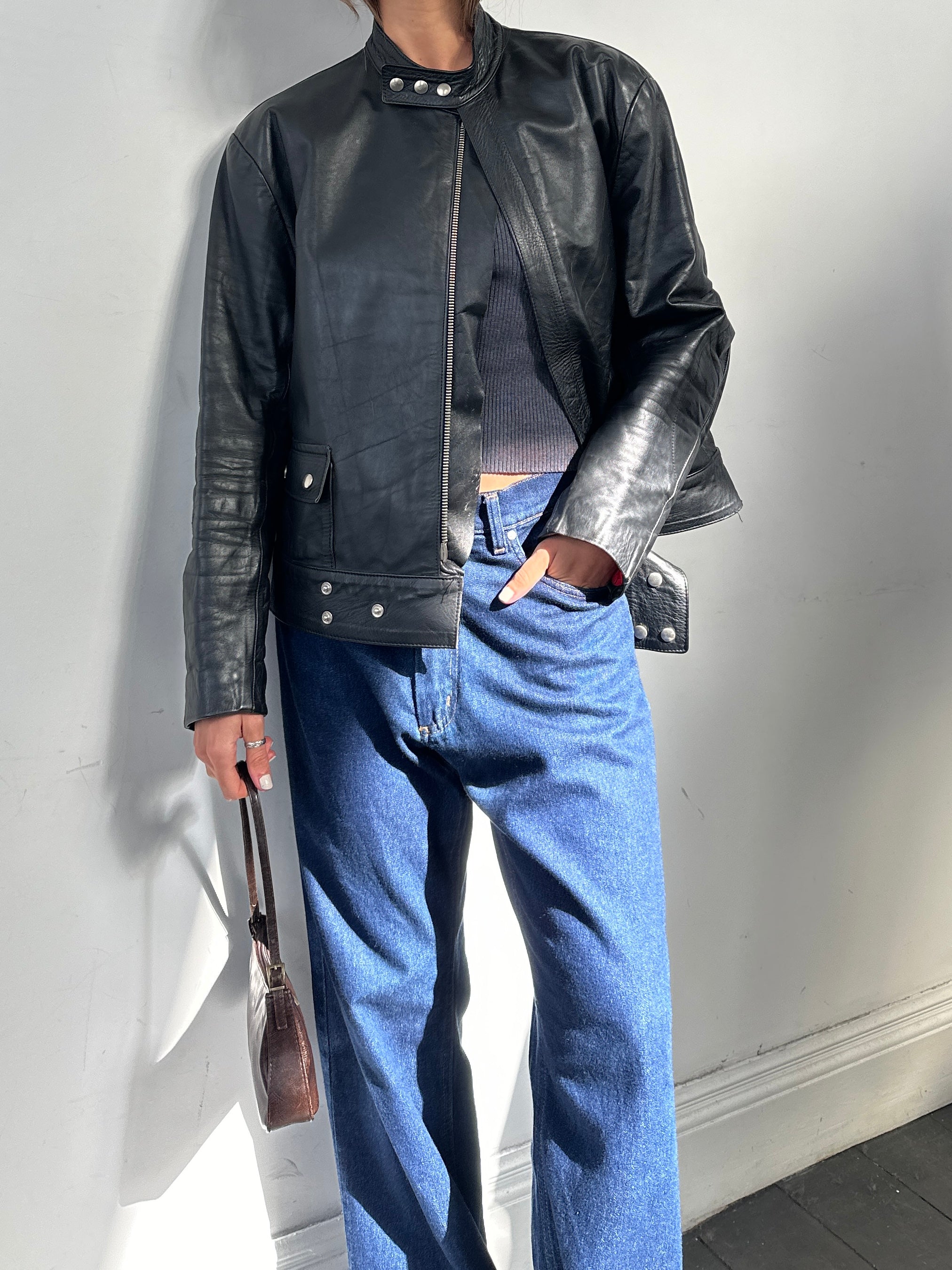 Vintage leather moto jacket in size large, featuring classic design and detailed stitching, styled for a timeless look.