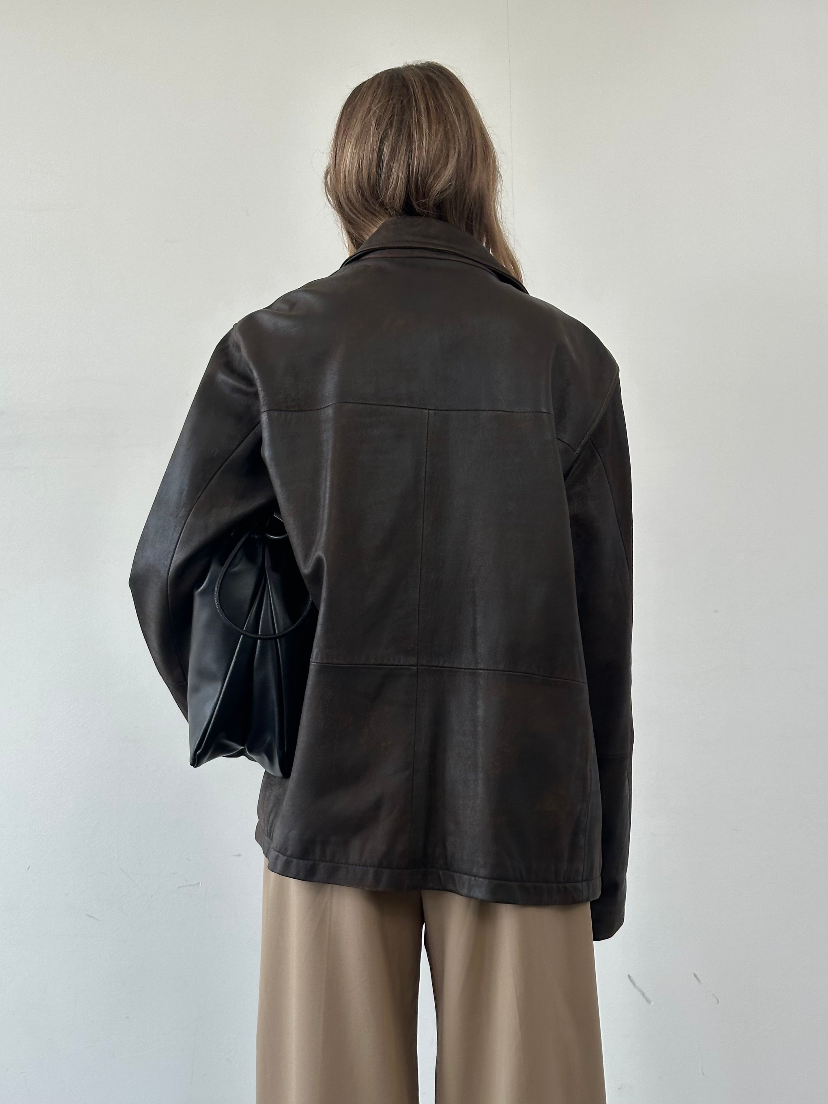 Vintage aged leather jacket in size XL, showcasing a rugged, classic leather design with detailed stitching and a worn finish.