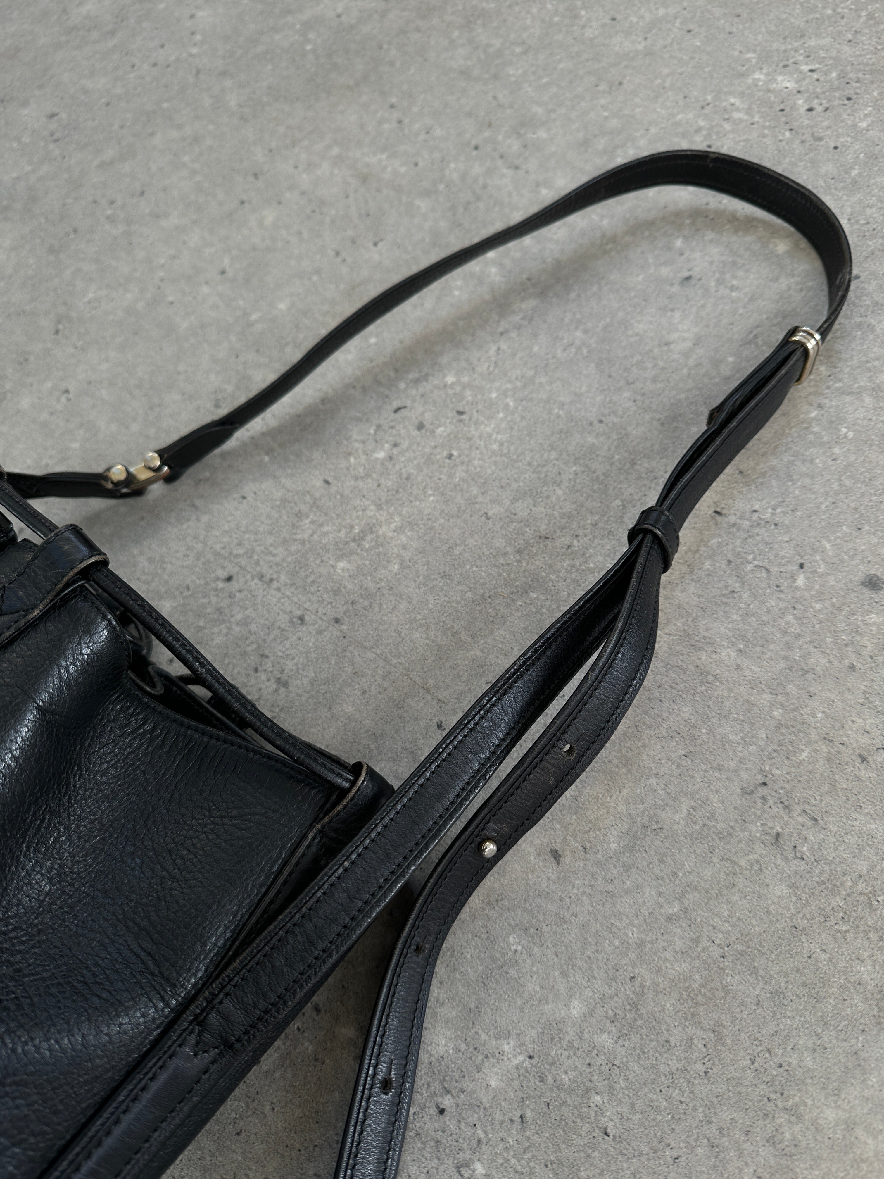 Cartier 1980s leather bucket bag with a drawstring closure and vintage design, featuring a smooth leather finish and subtle branding.