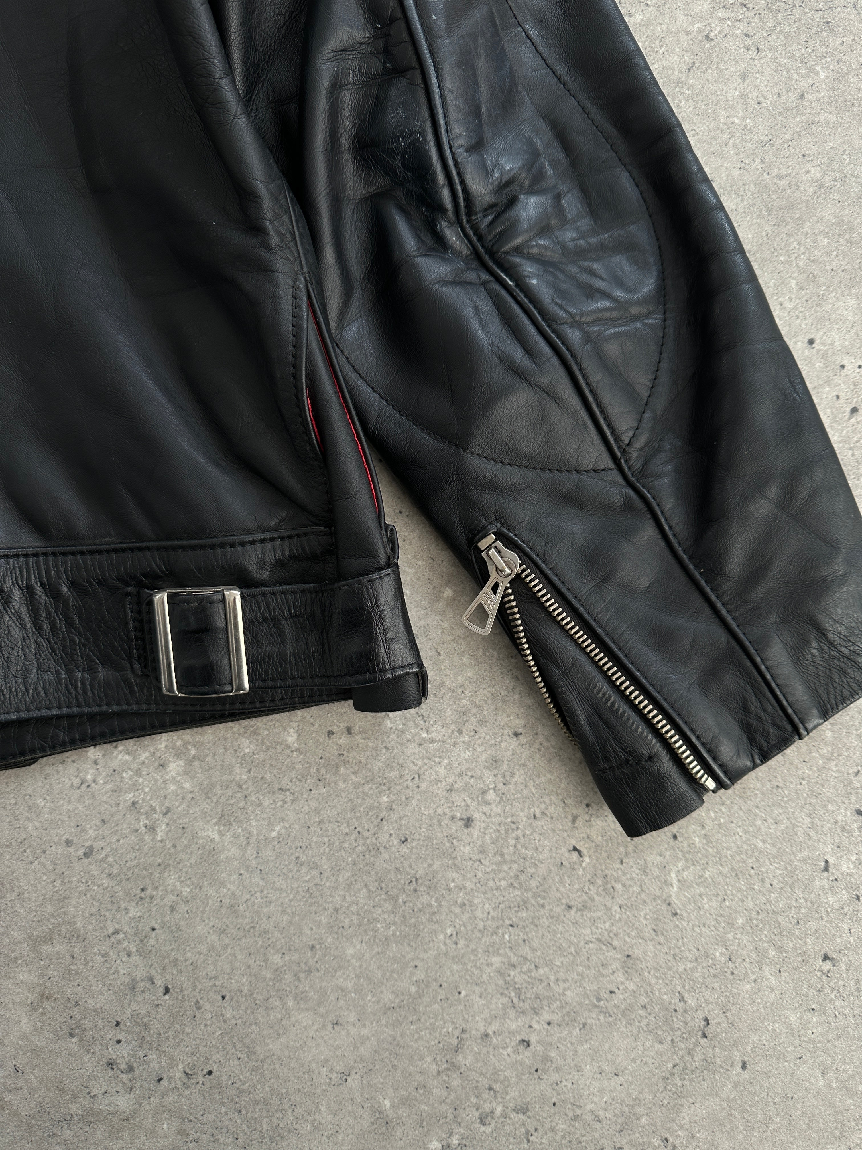 Vintage leather moto jacket in size large, featuring classic design with shoulder epaulets and zip details.