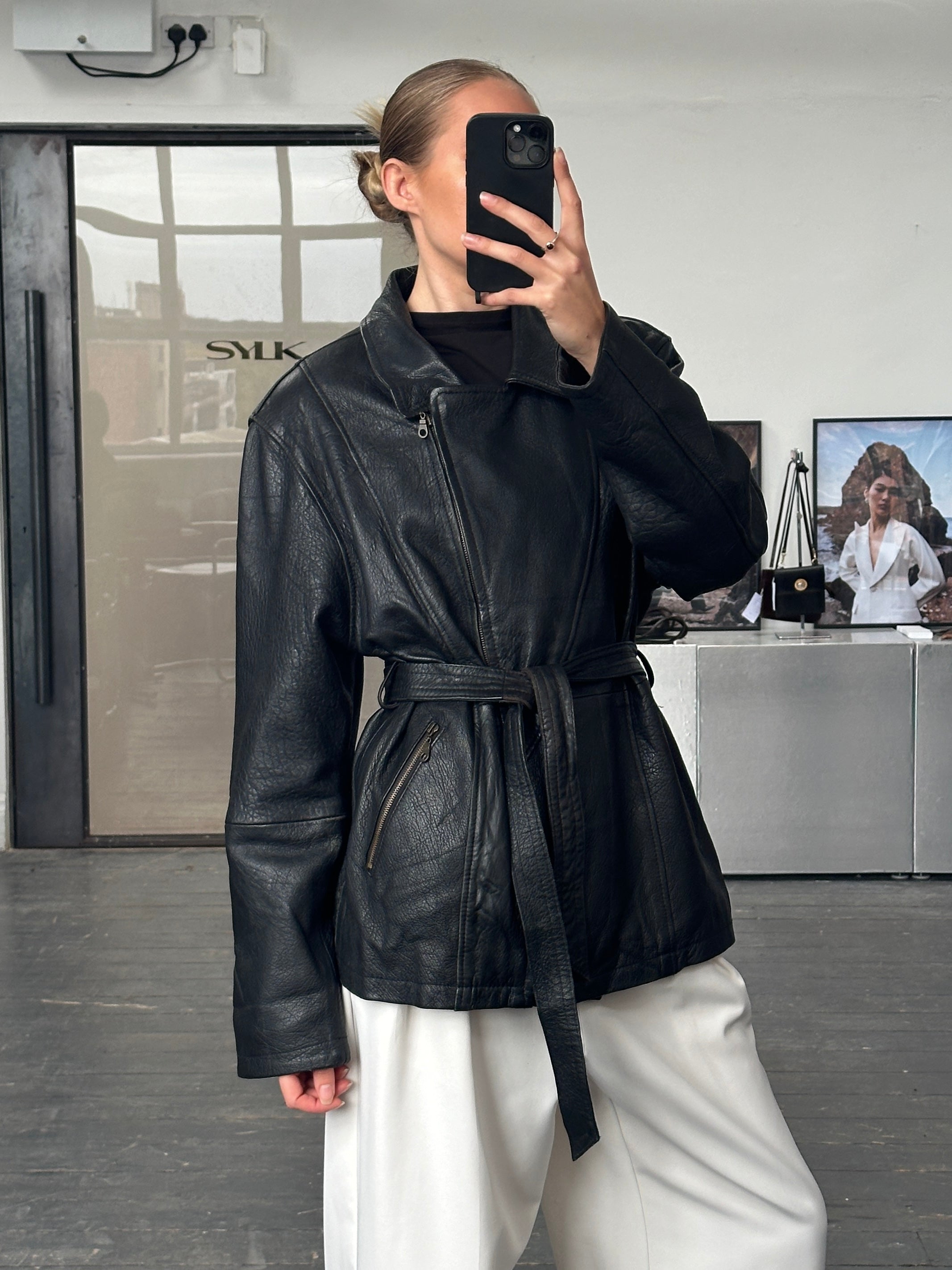 Vintage 1990s lamb leather belted jacket in XL, featuring classic design and high-quality leather, worn style with belt accents.