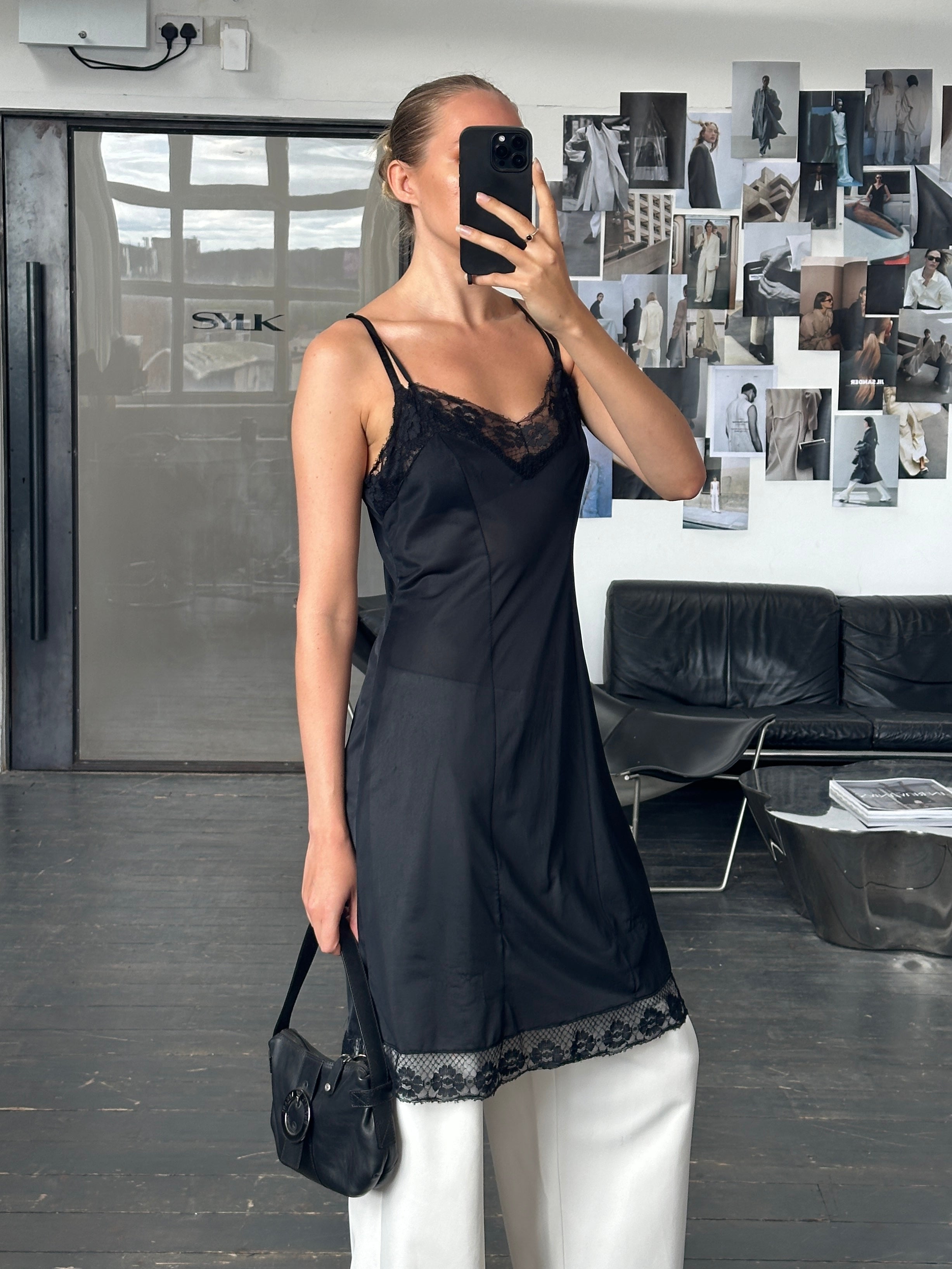 Vintage 1980s lace semi-sheer slip dress in size M, featuring delicate fabric and classic retro style.