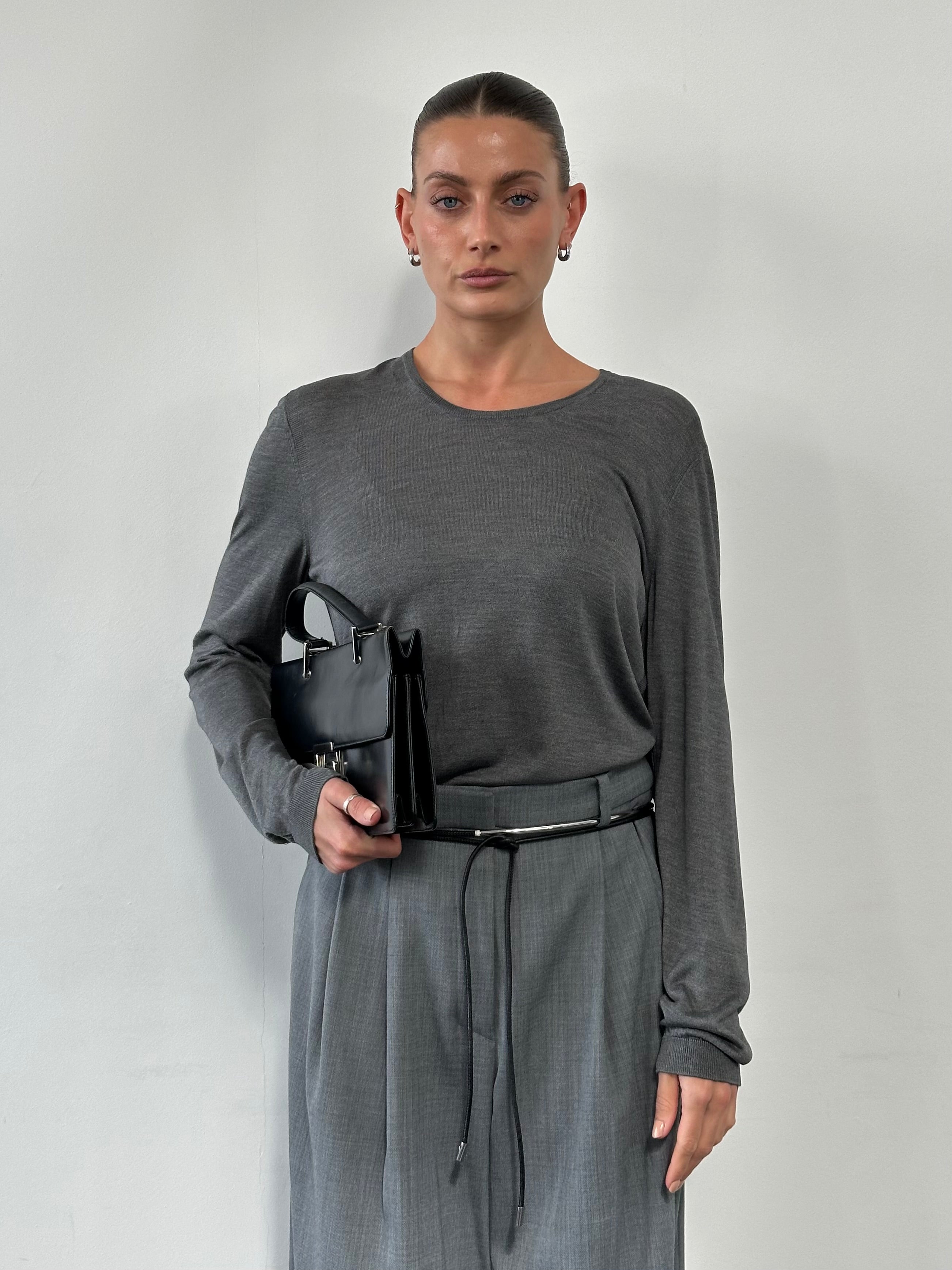 Gucci pure silk lightweight knitted jumper in soft cream, displayed on a hanger with a close-up of the fabric texture.