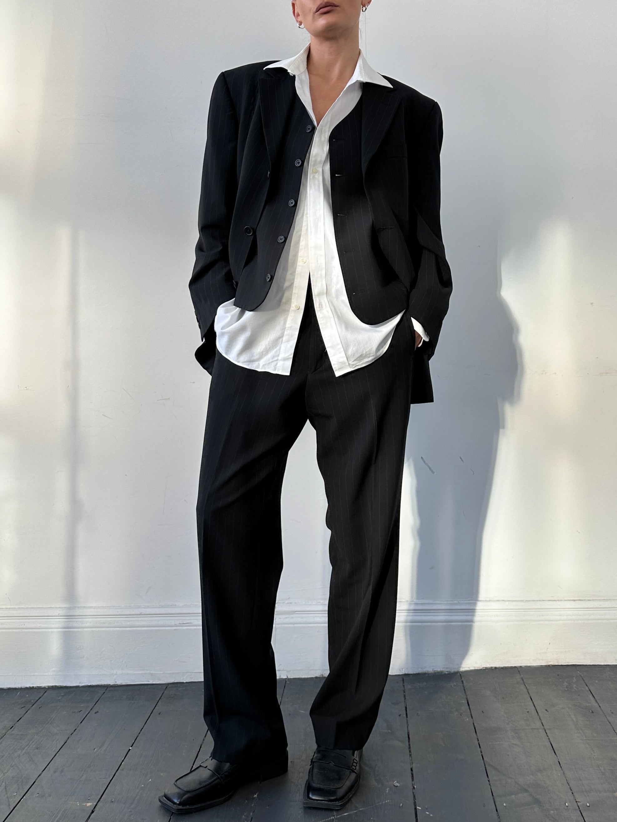 Vintage pinstripe wool three-piece suit in size 40R/W32, featuring classic tailored design and notch lapel jacket.