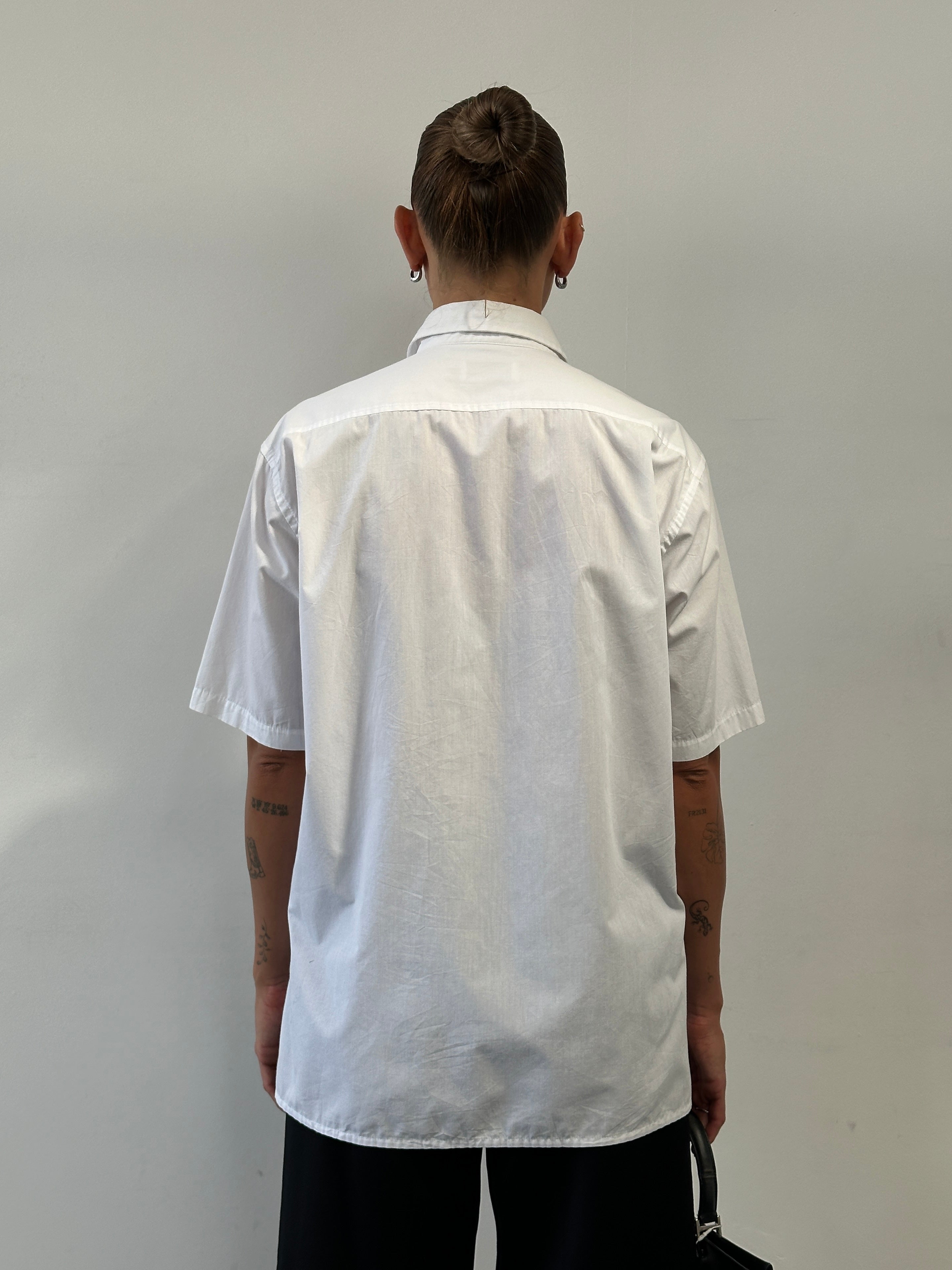 Yves Saint Laurent Pour Homme cotton short sleeve logo shirt in size L, featuring classic design and brand logo on the front.