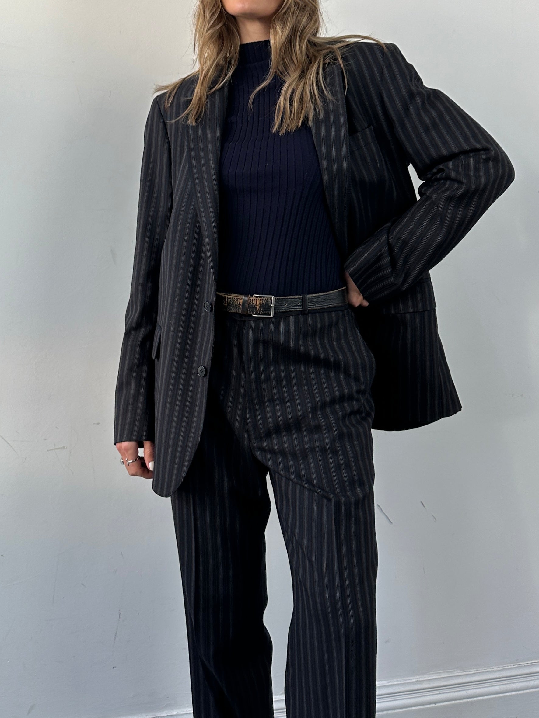 Christian Dior pure wool pinstripe jumpsuit in 42L/W34, featuring tailored fit and classic pinstripe pattern.