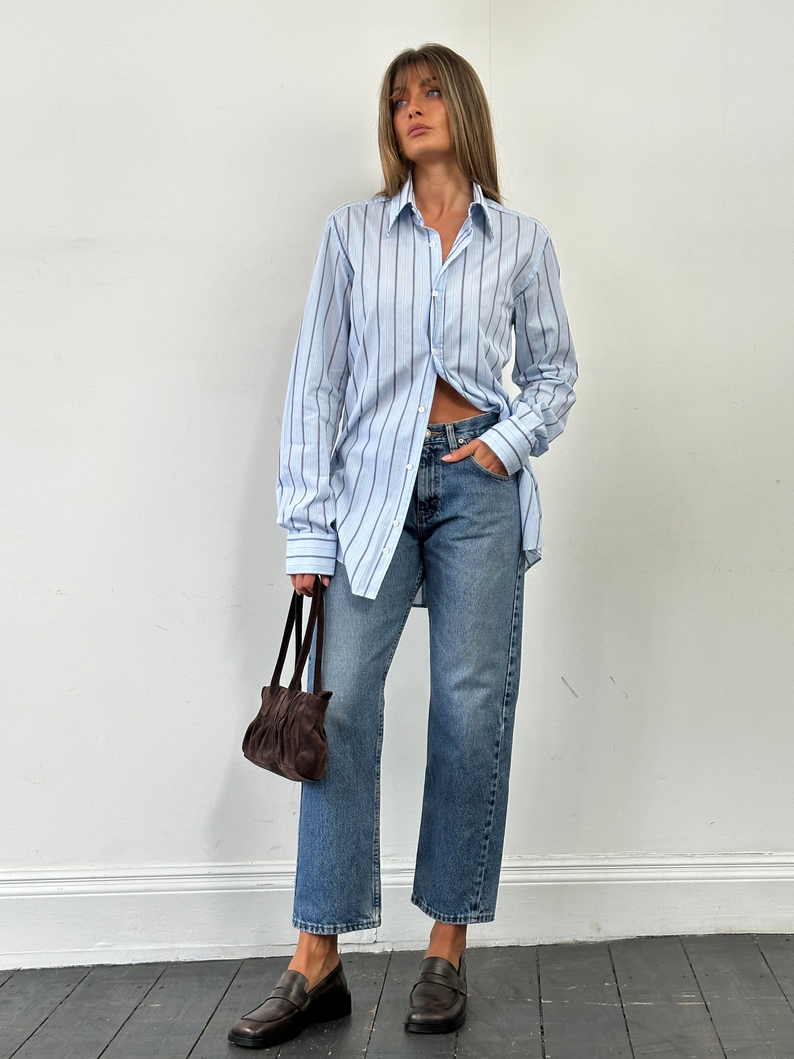 Wrangler mid wash straight leg high waisted denim jeans, front view showing classic five-pocket design and belt loops.