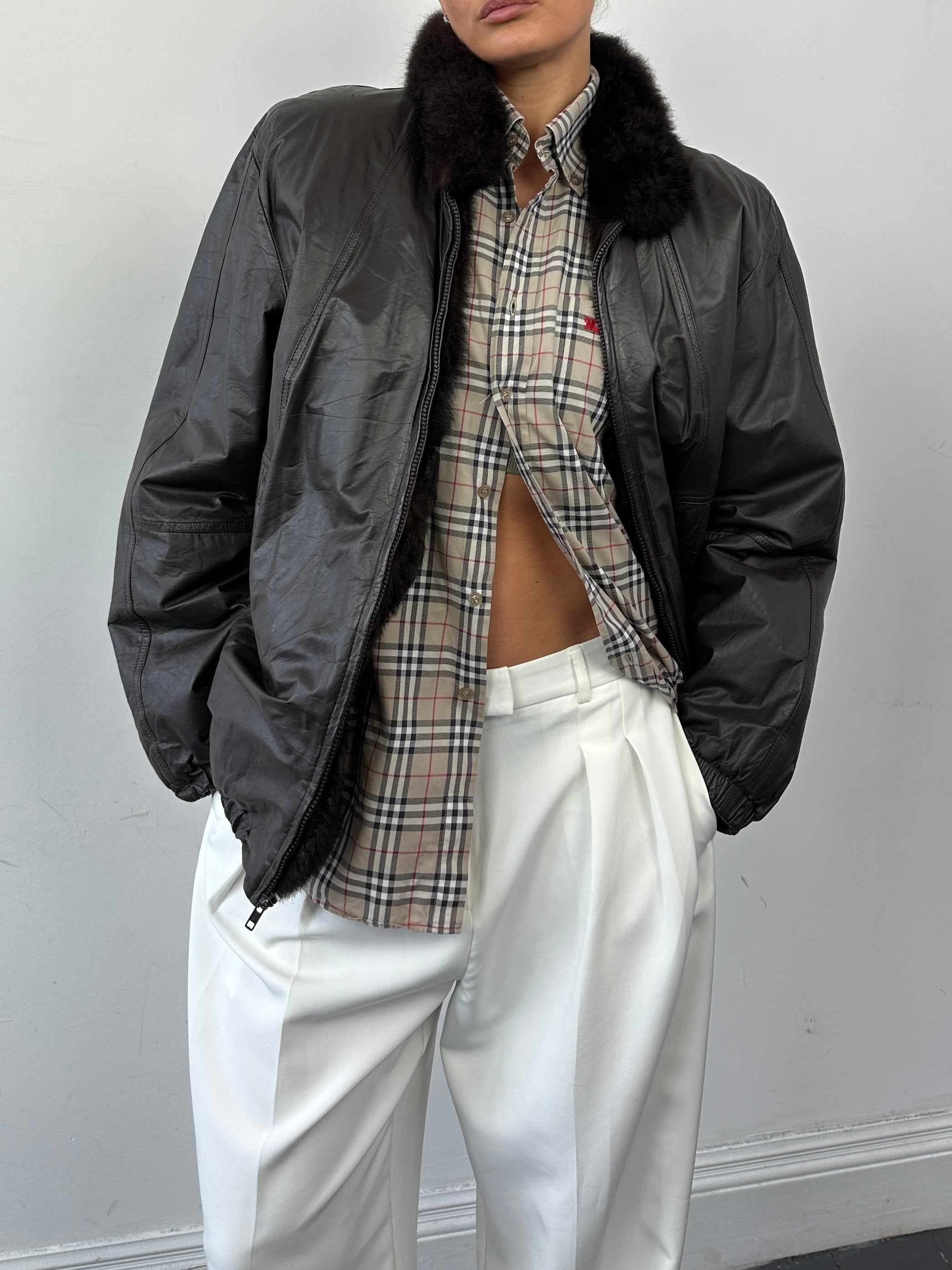Vintage faux fur-lined minimal leather bomber jacket, size S, stylish and warm, featuring sleek leather exterior and cozy fur lining.