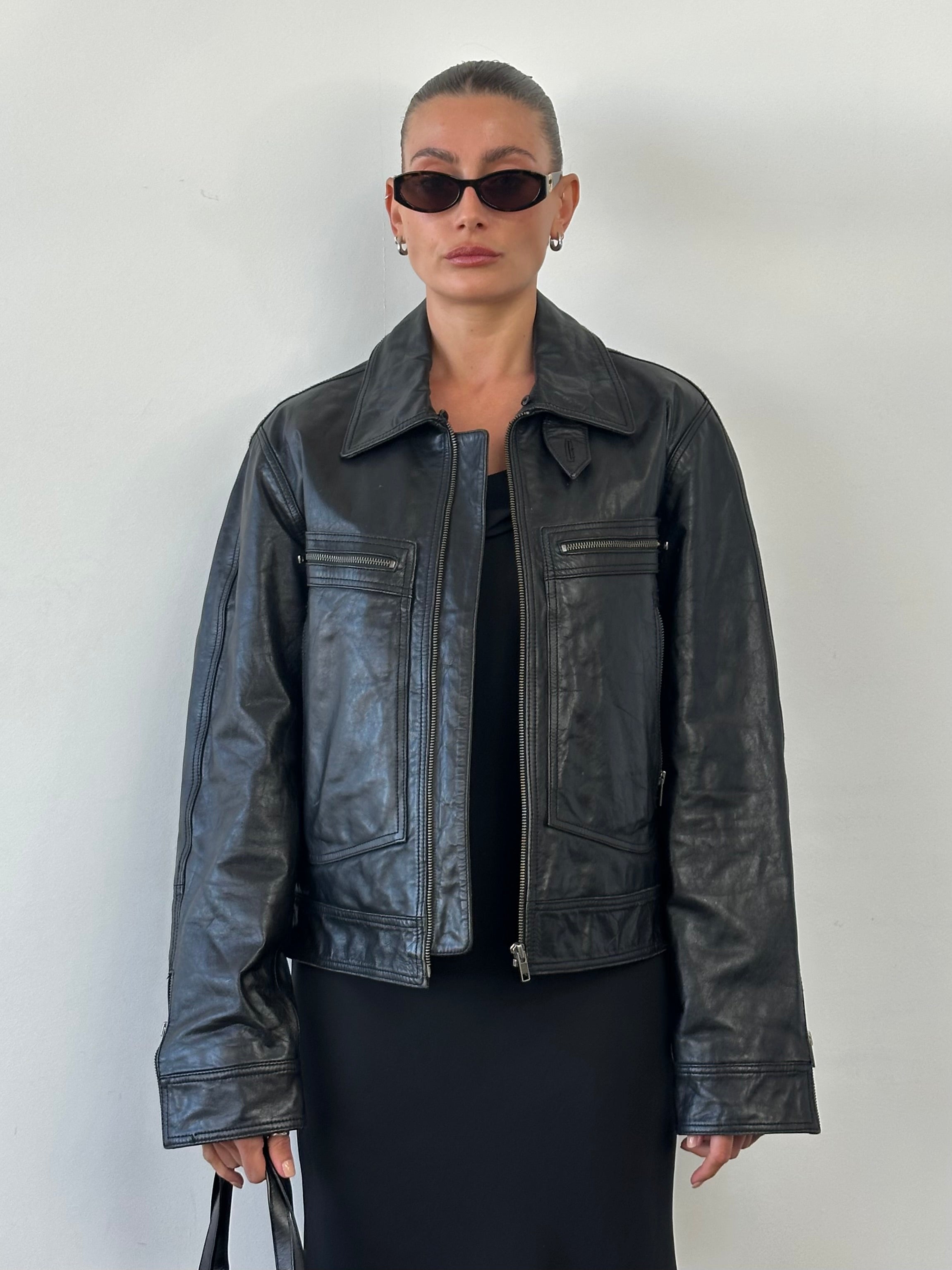 Conbipel high neck leather jacket in black, tailored fit, featuring a sleek design and high collar for a stylish look.