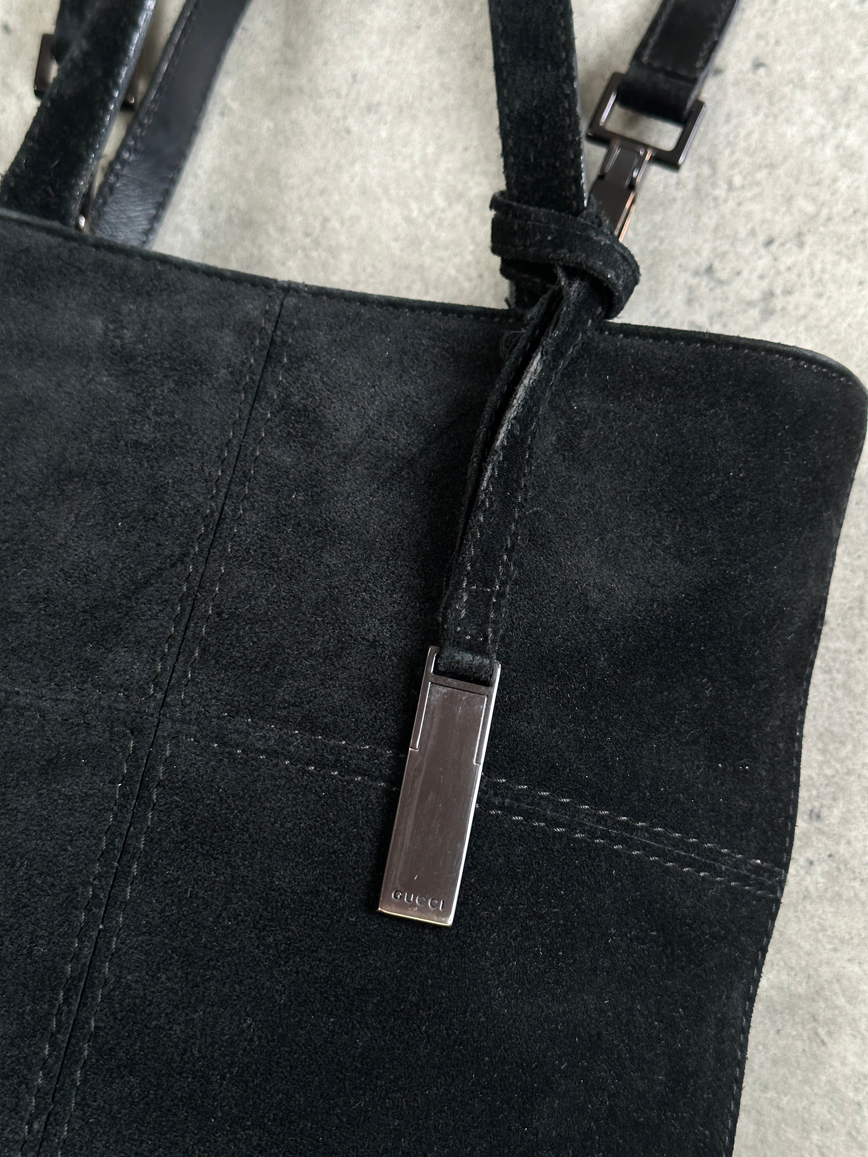 Gucci suede top handle crossbody bag with structured design and adjustable strap, featuring classic luxury style.