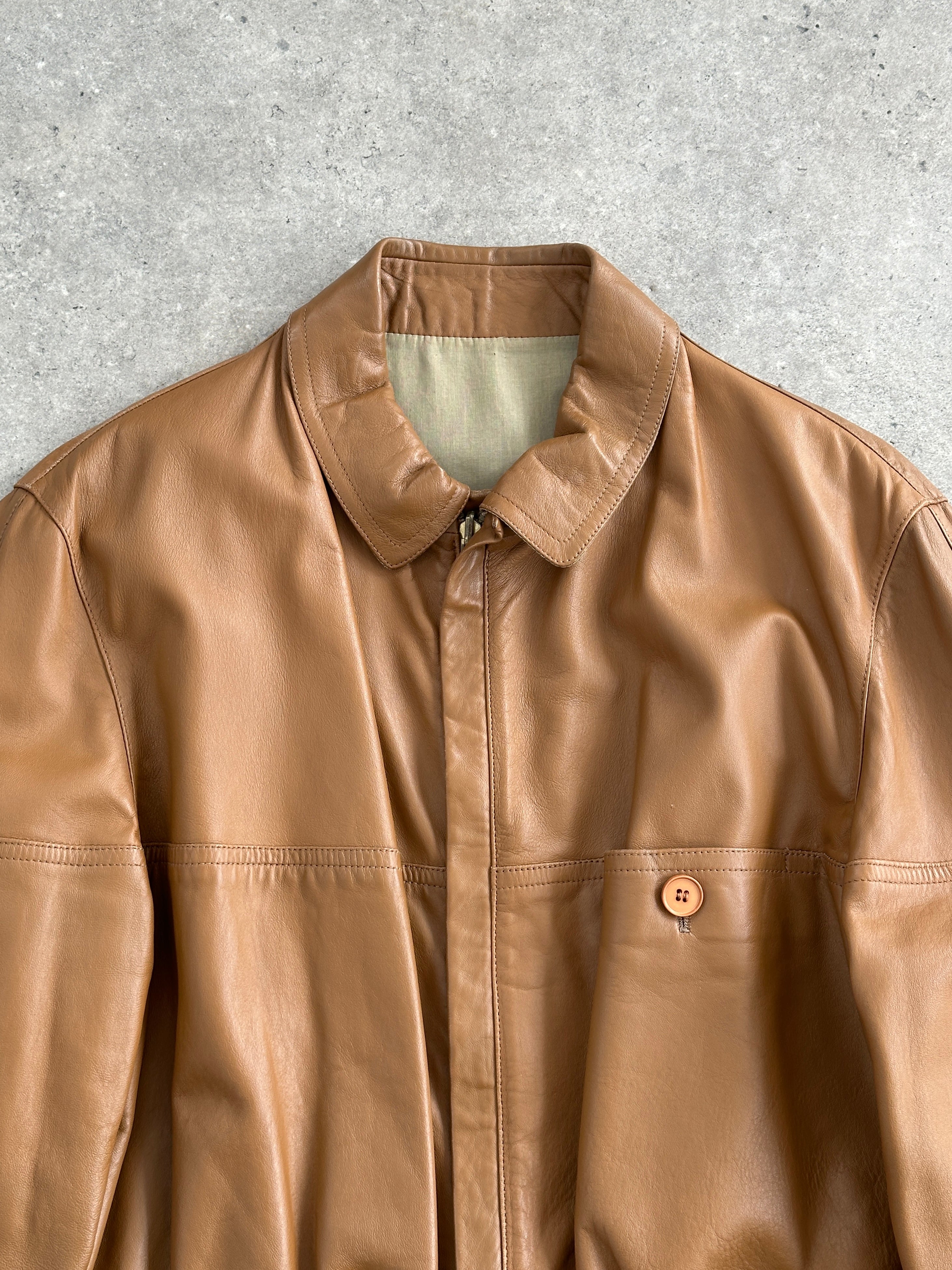 Vintage Italian 1980s reversible leather jacket with cinched waist in size XL, stylish retro design and classic craftsmanship.